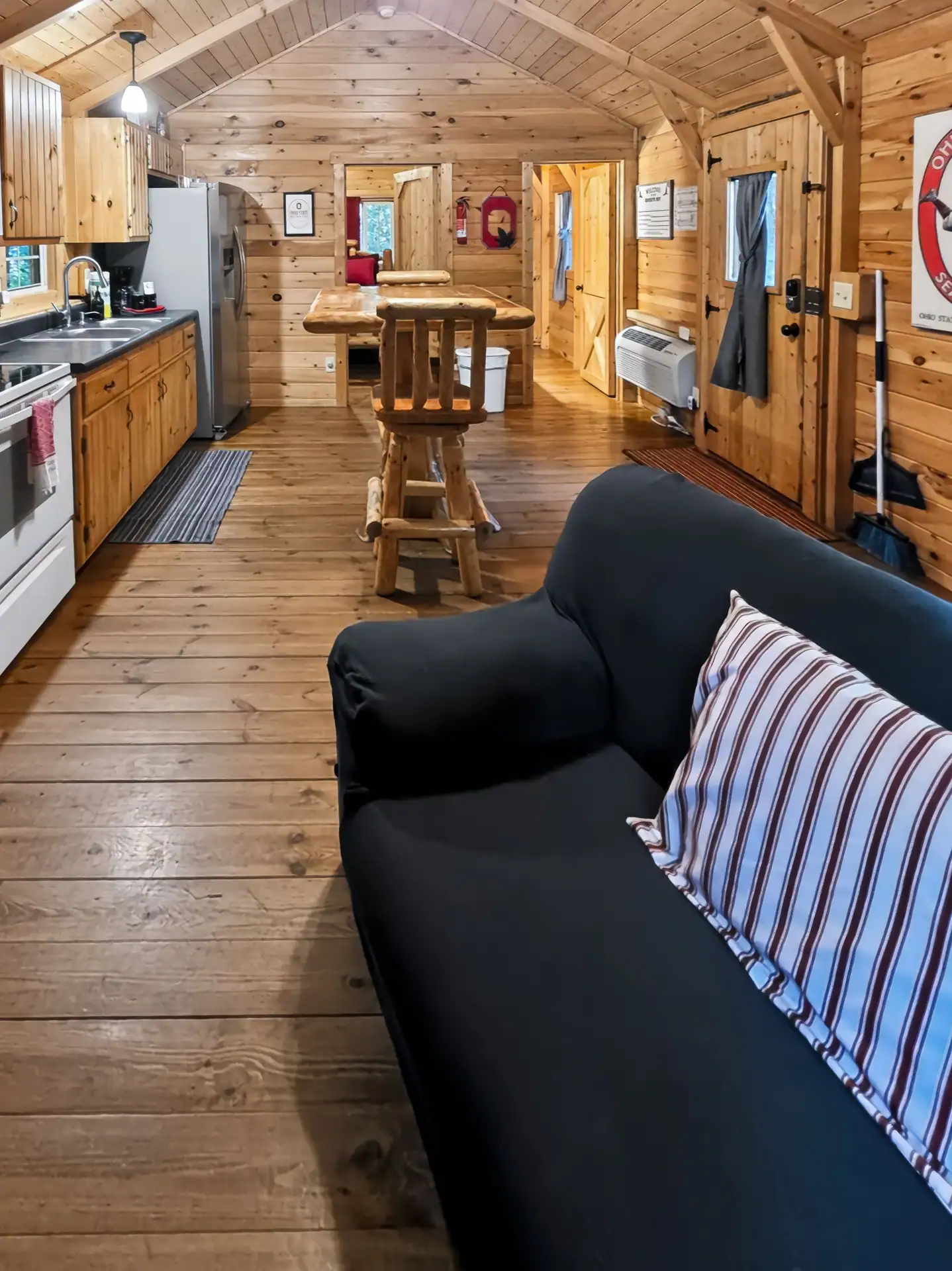 View from the sofa across the living area to the kitchen at Buckeye Hut cabin