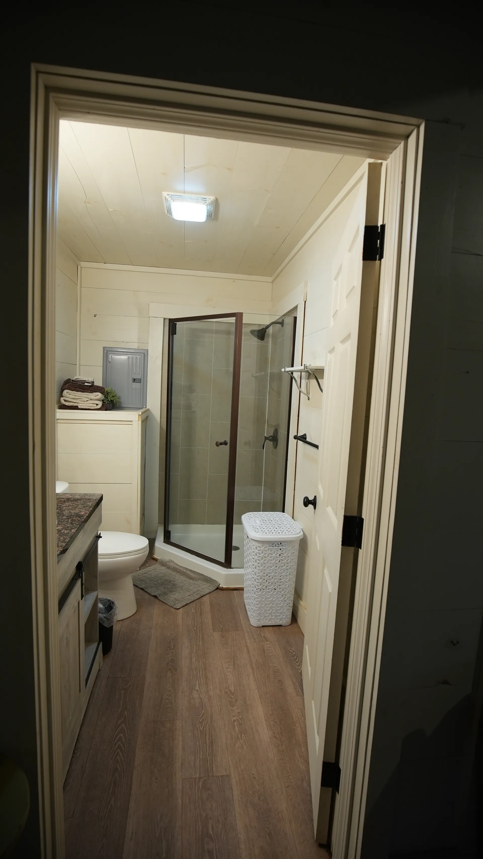 Full bathroom with glass shower, vanity, and white shiplap walls at Butterfly Ridge cabin