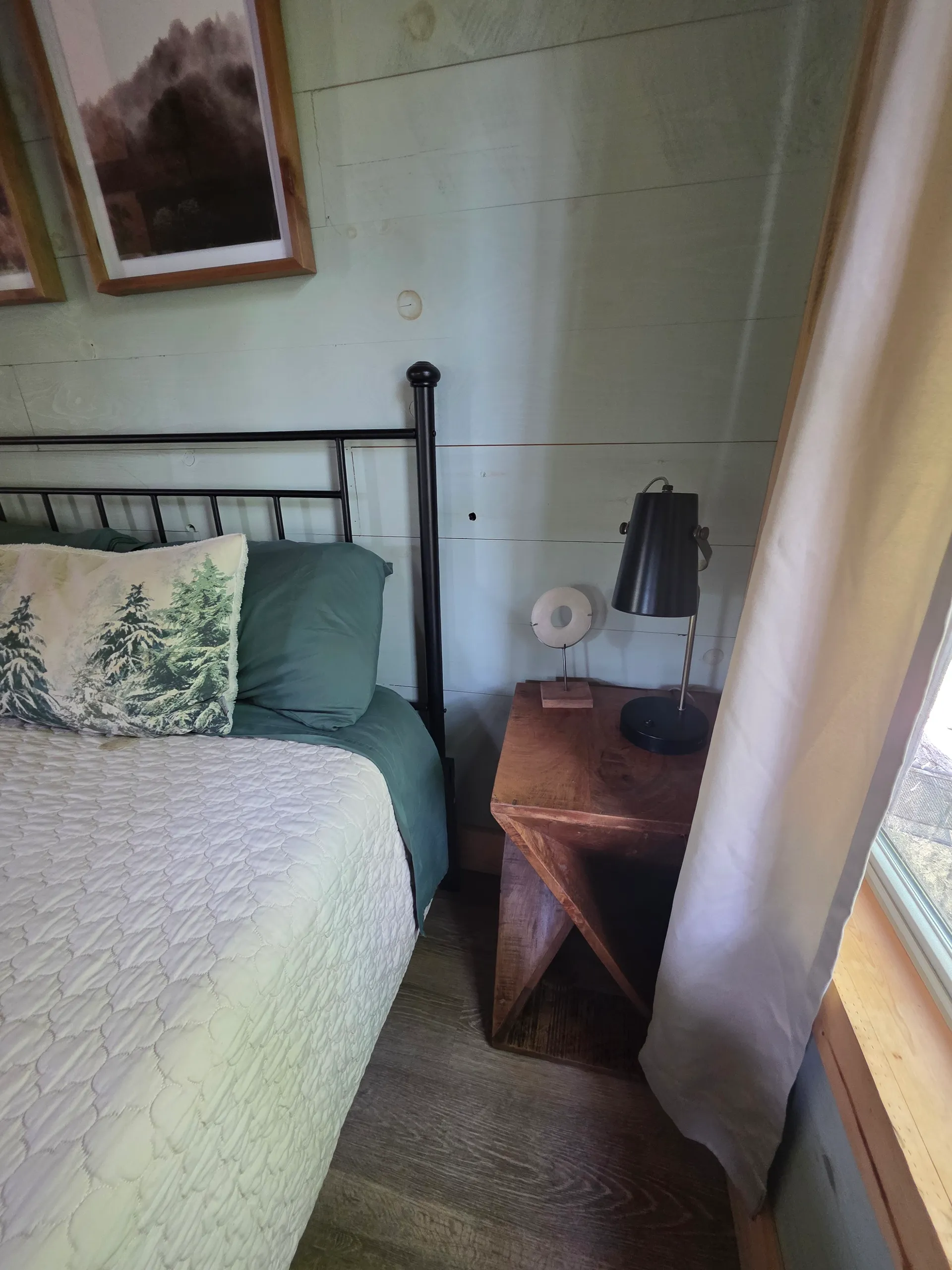 Open living space with cedar fireplace, hanging egg chair, and loft view at Butterfly Ridge cabin