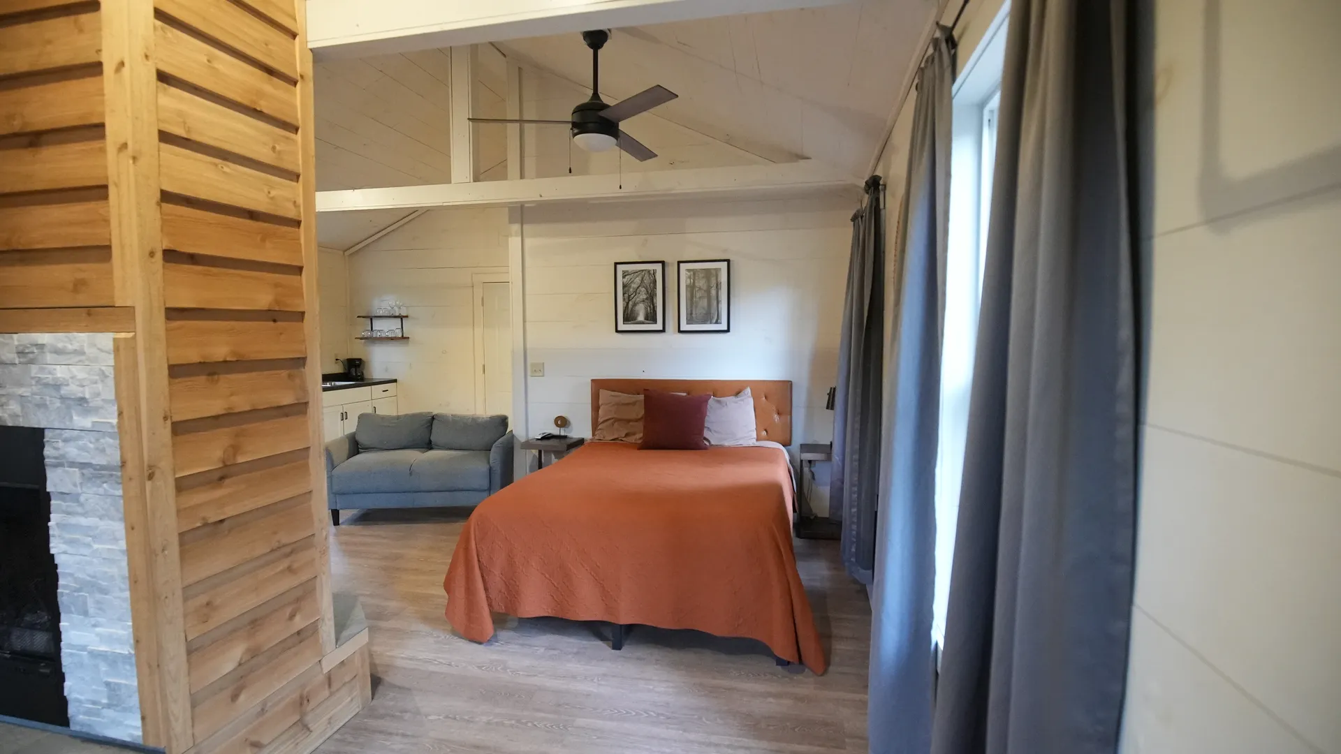 Wide interior view showing kitchenette, dining table, and sliding glass door at Butterfly Ridge cabin