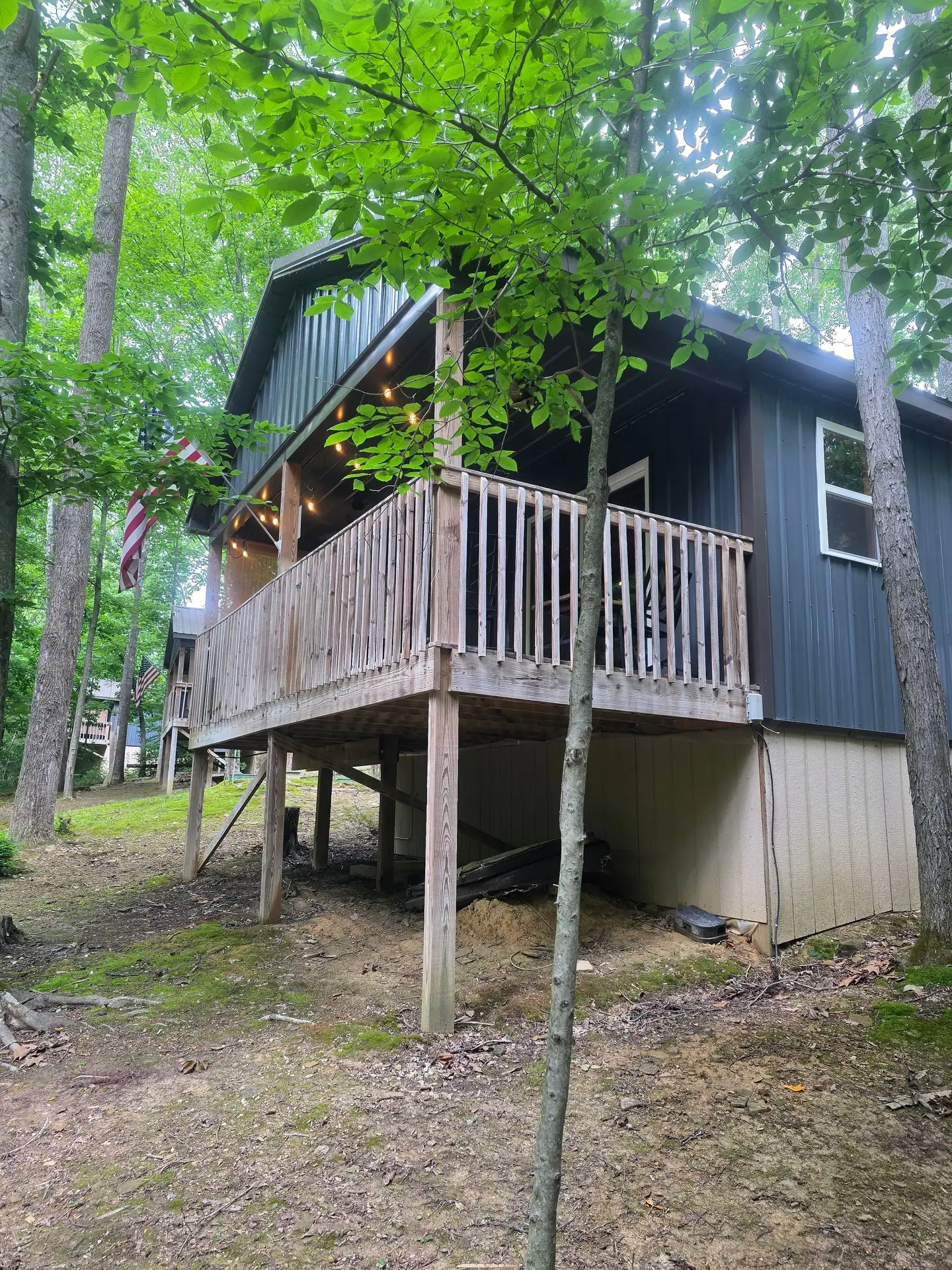 Raised covered deck seen from the wooded side yard at Dogwood Run cabin