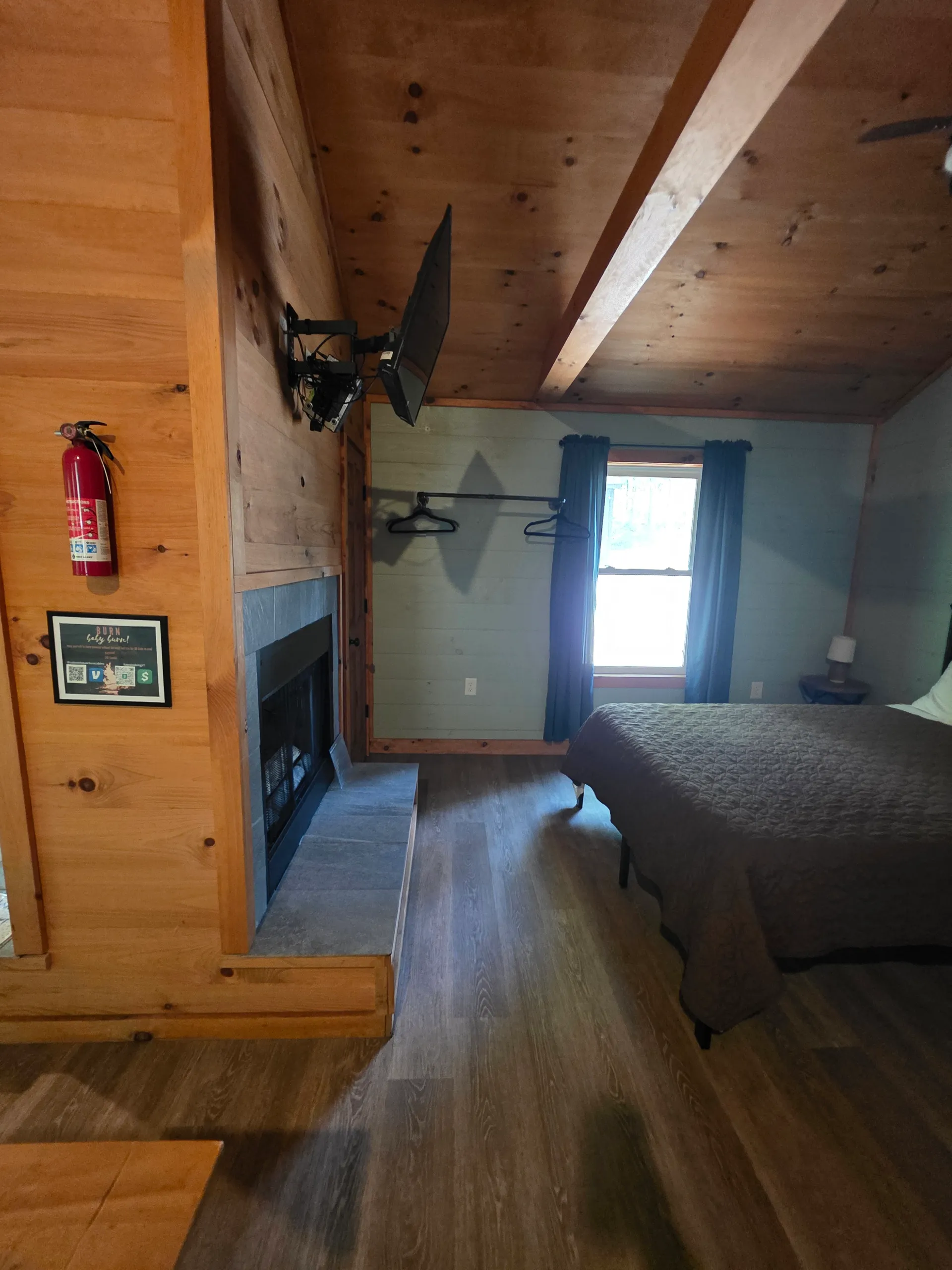Fireplace and TV wall viewed from the bed at Dogwood Run cabin
