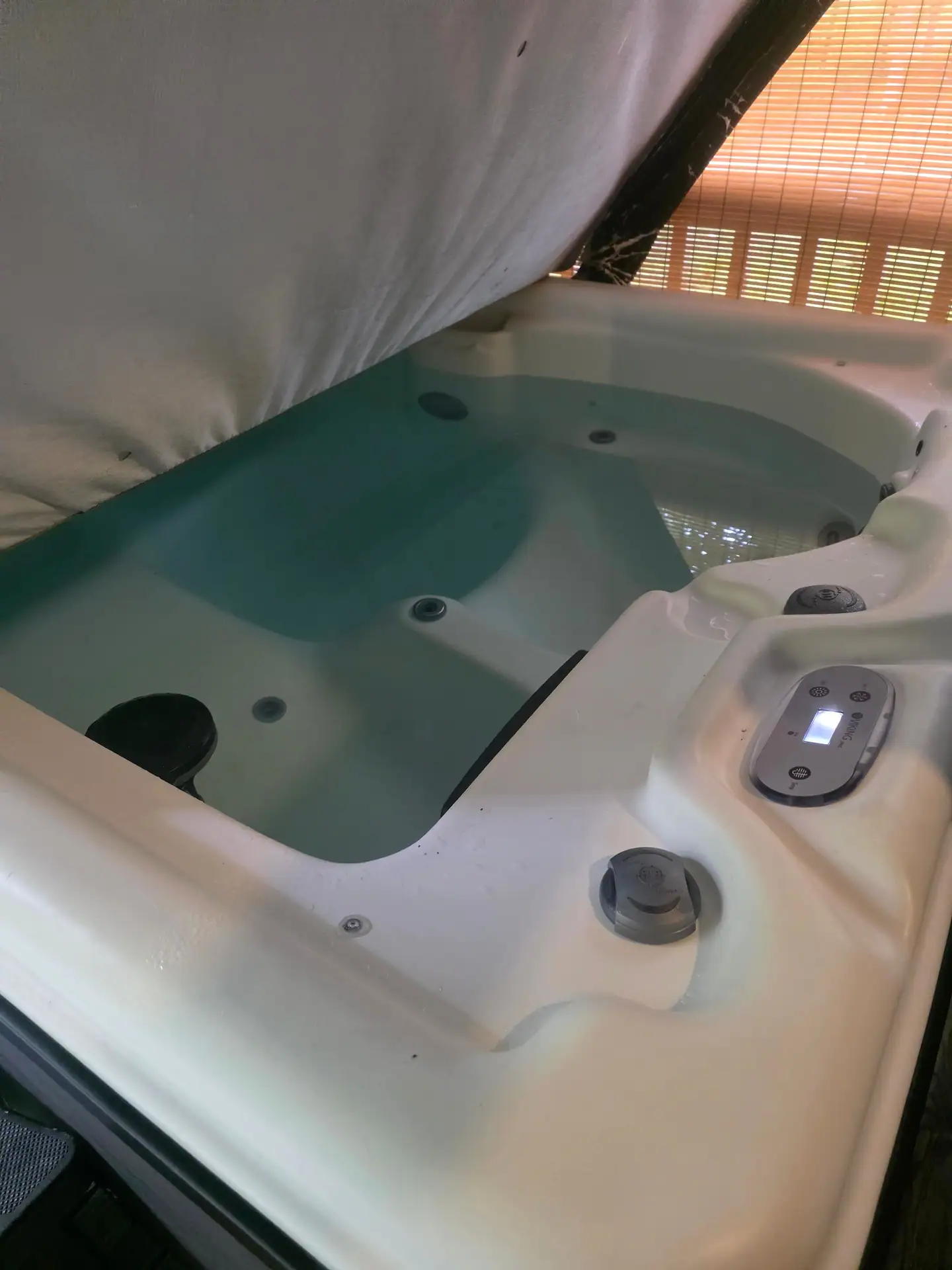 Private hot tub with the cover open on the covered deck at Dogwood Run cabin