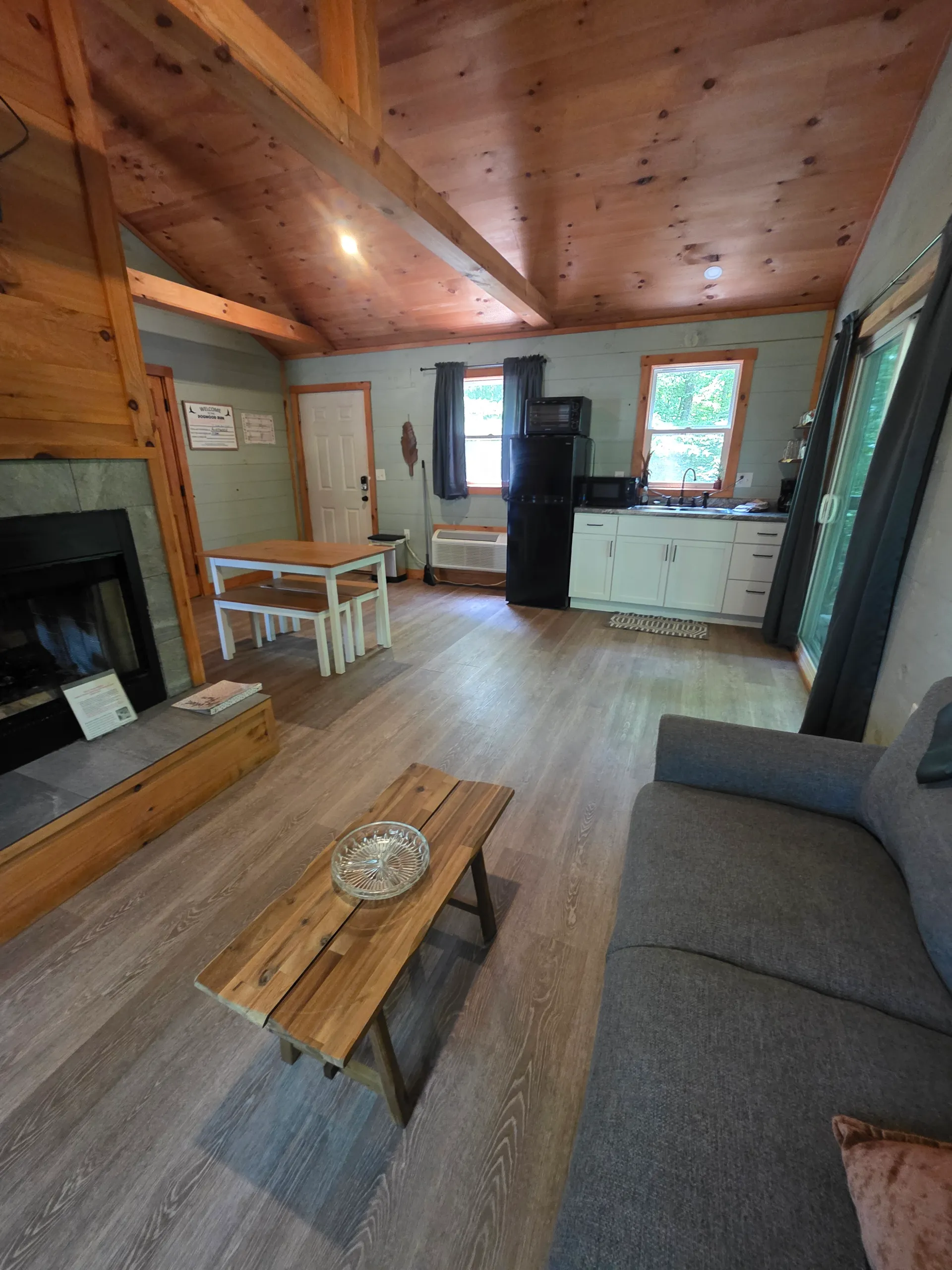 Dining table with bench and kitchen counter with wooden accents at Dogwood Run cabin