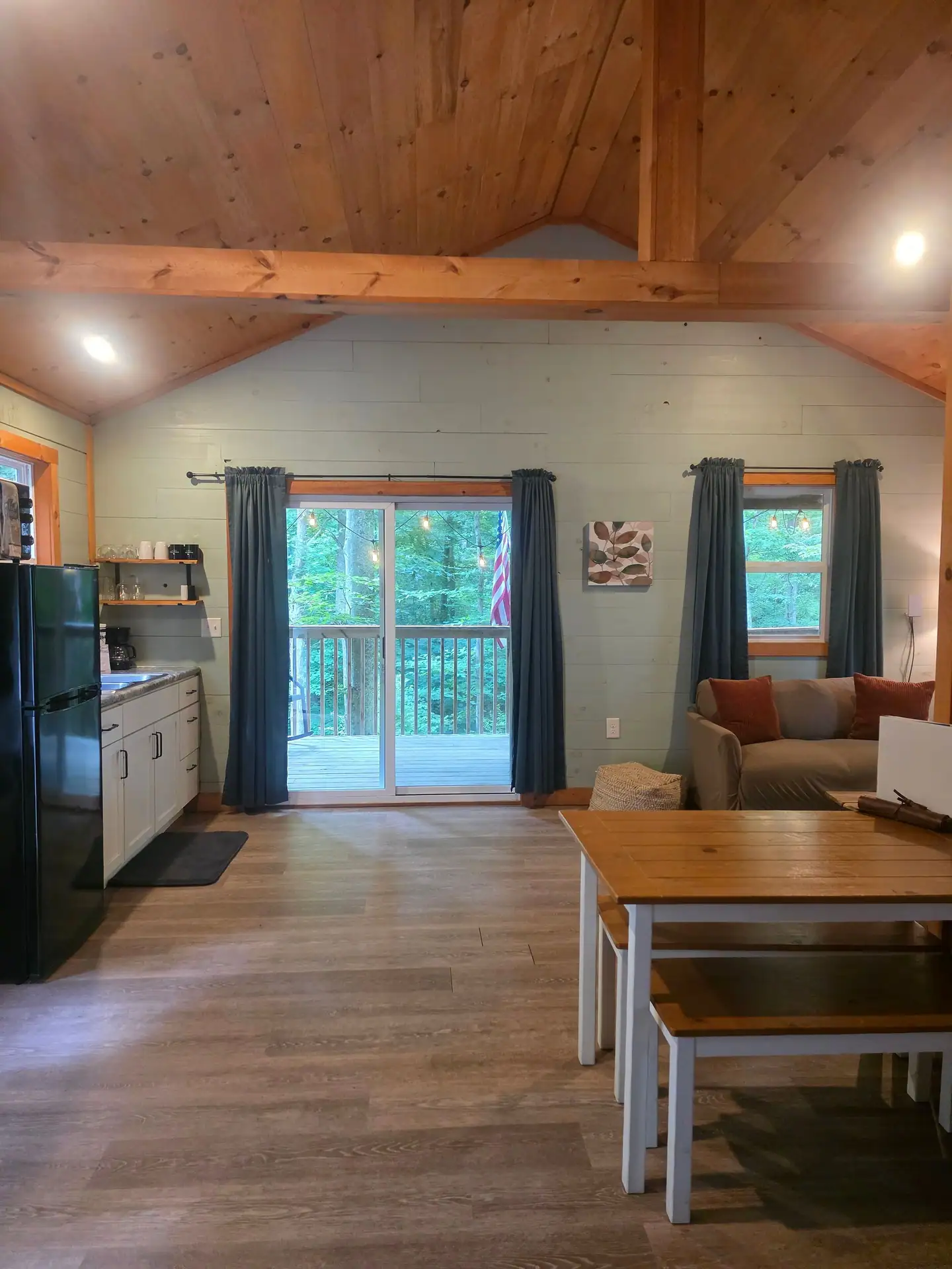 Living space with vaulted wood ceiling seen from the bedroom side at Dogwood Run cabin