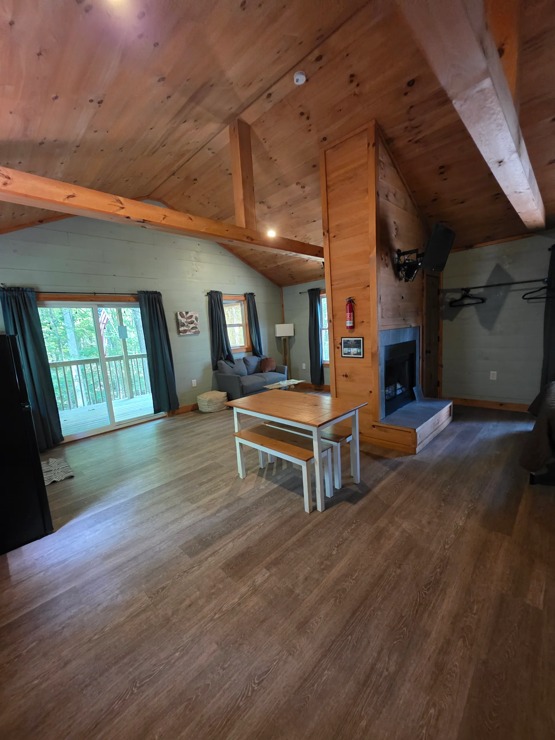 Wide interior view showing living area, fireplace, kitchen, and dining at Dogwood Run cabin