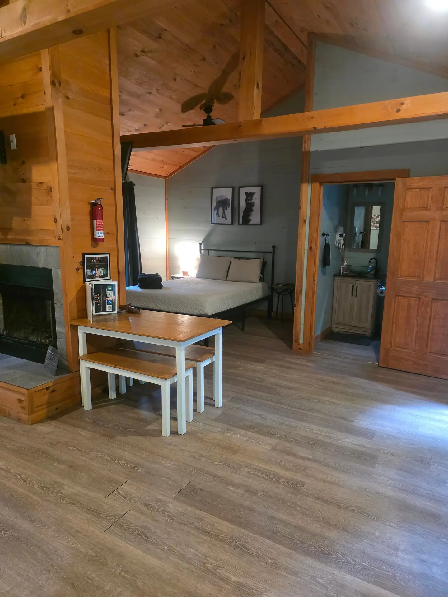 View from the living area past the dining table into the bedroom at Dogwood Run cabin