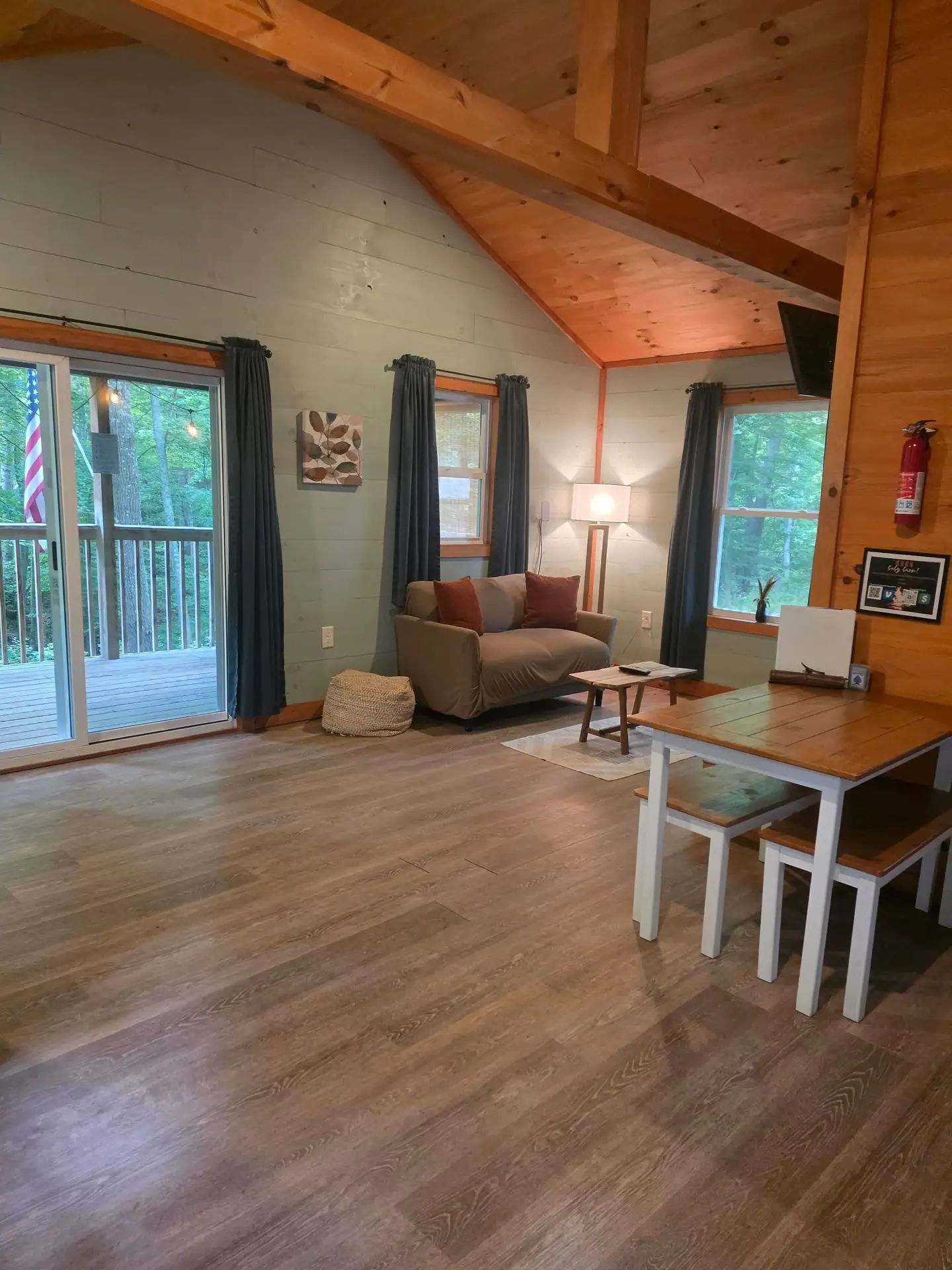 Living area with sofa and dining table with bench seating at Dogwood Run cabin