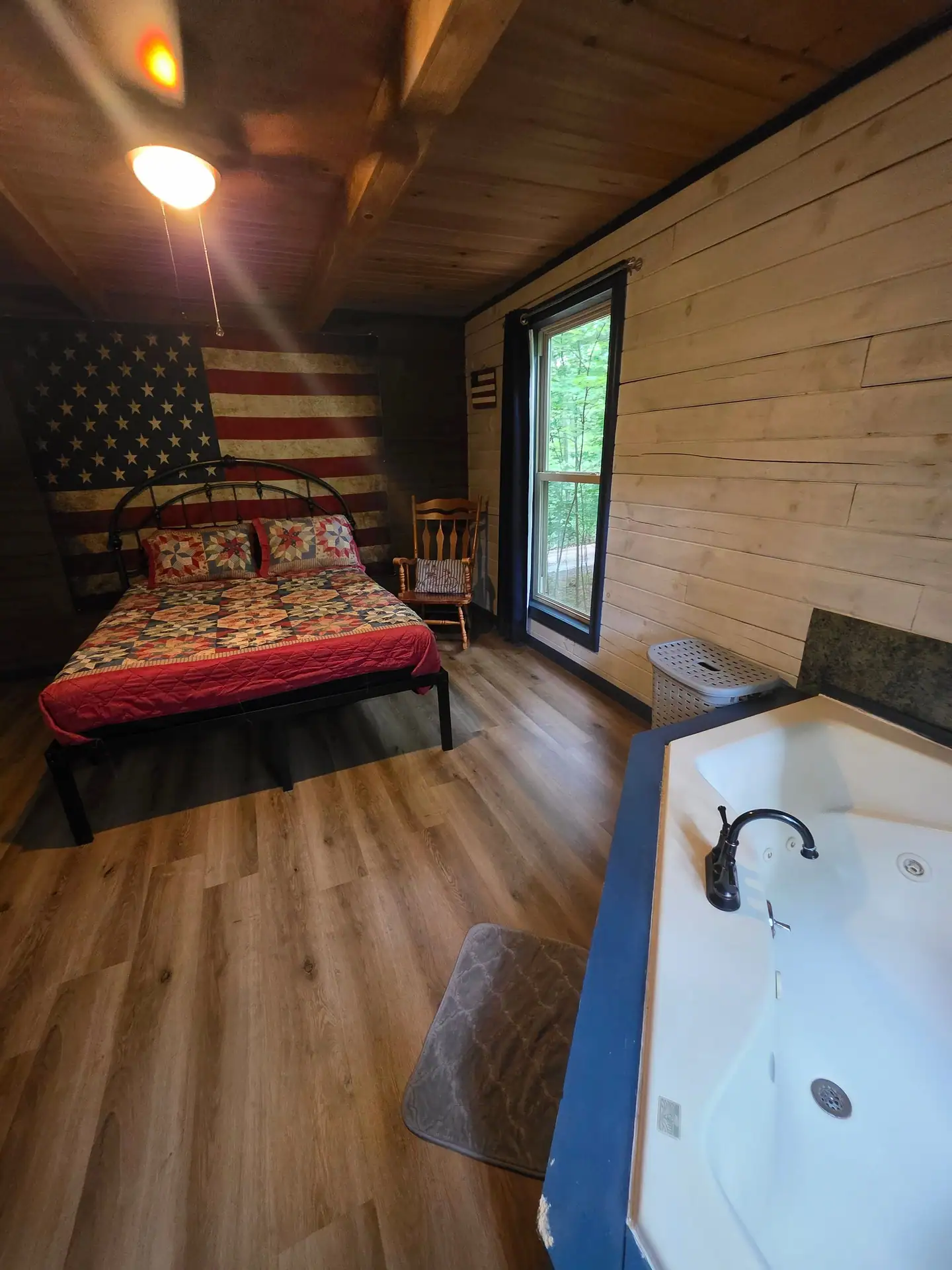 Indoor jacuzzi tub at the foot of the bedroom in Eagles Nest cabin