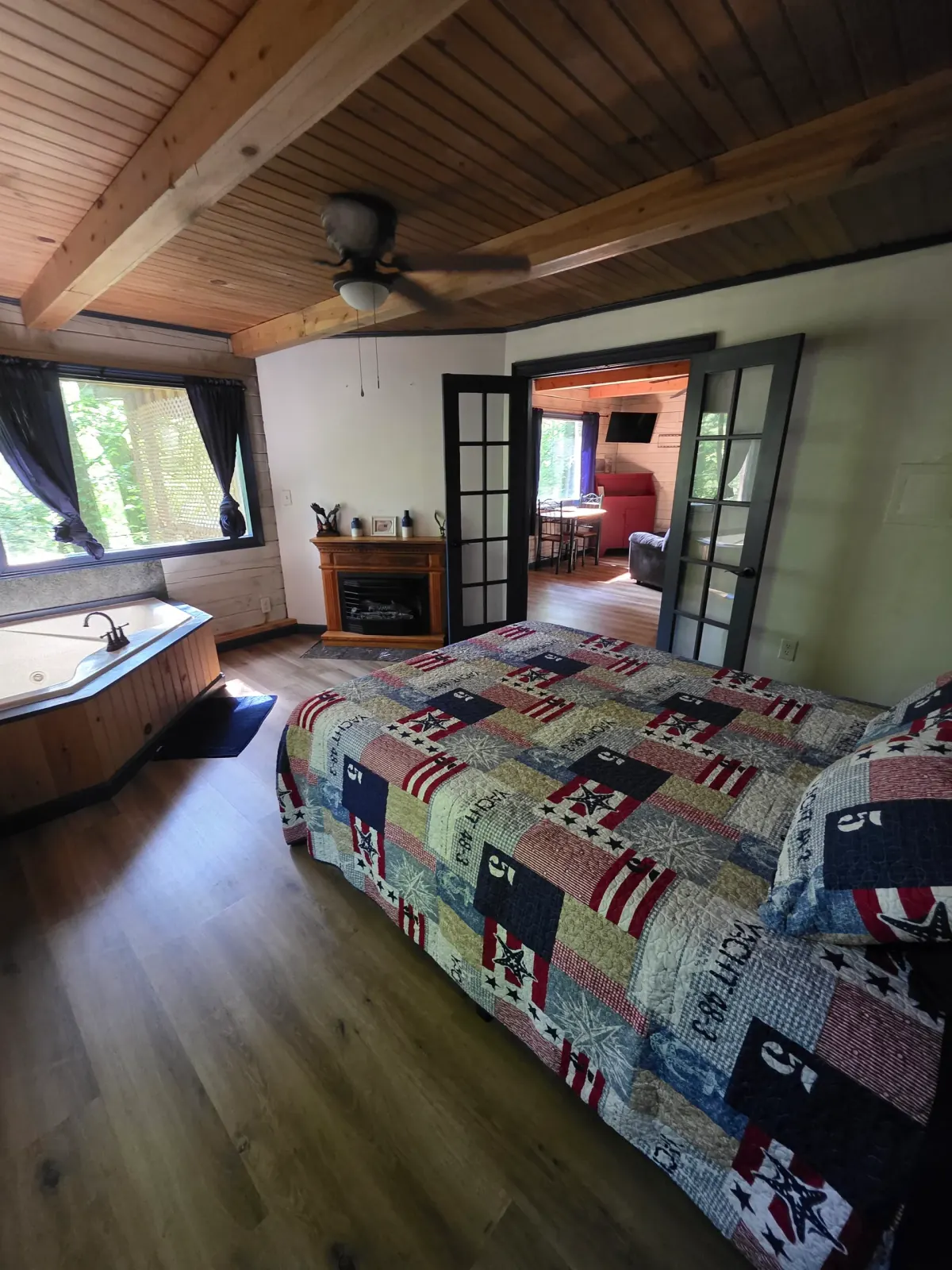 Eagles Nest cabin bedroom with patriotic quilt and open loft view of living area below