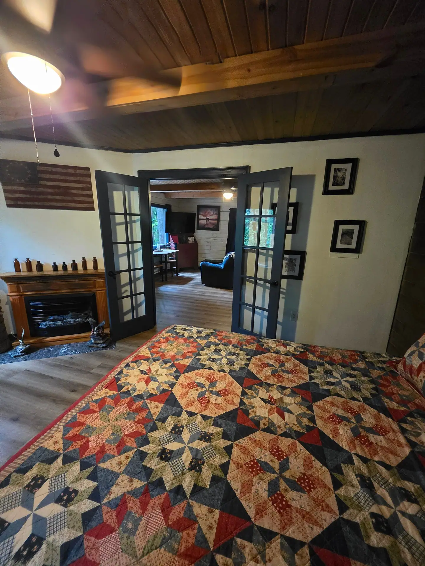 View from the bed through French doors into the living room at Eagles Nest cabin