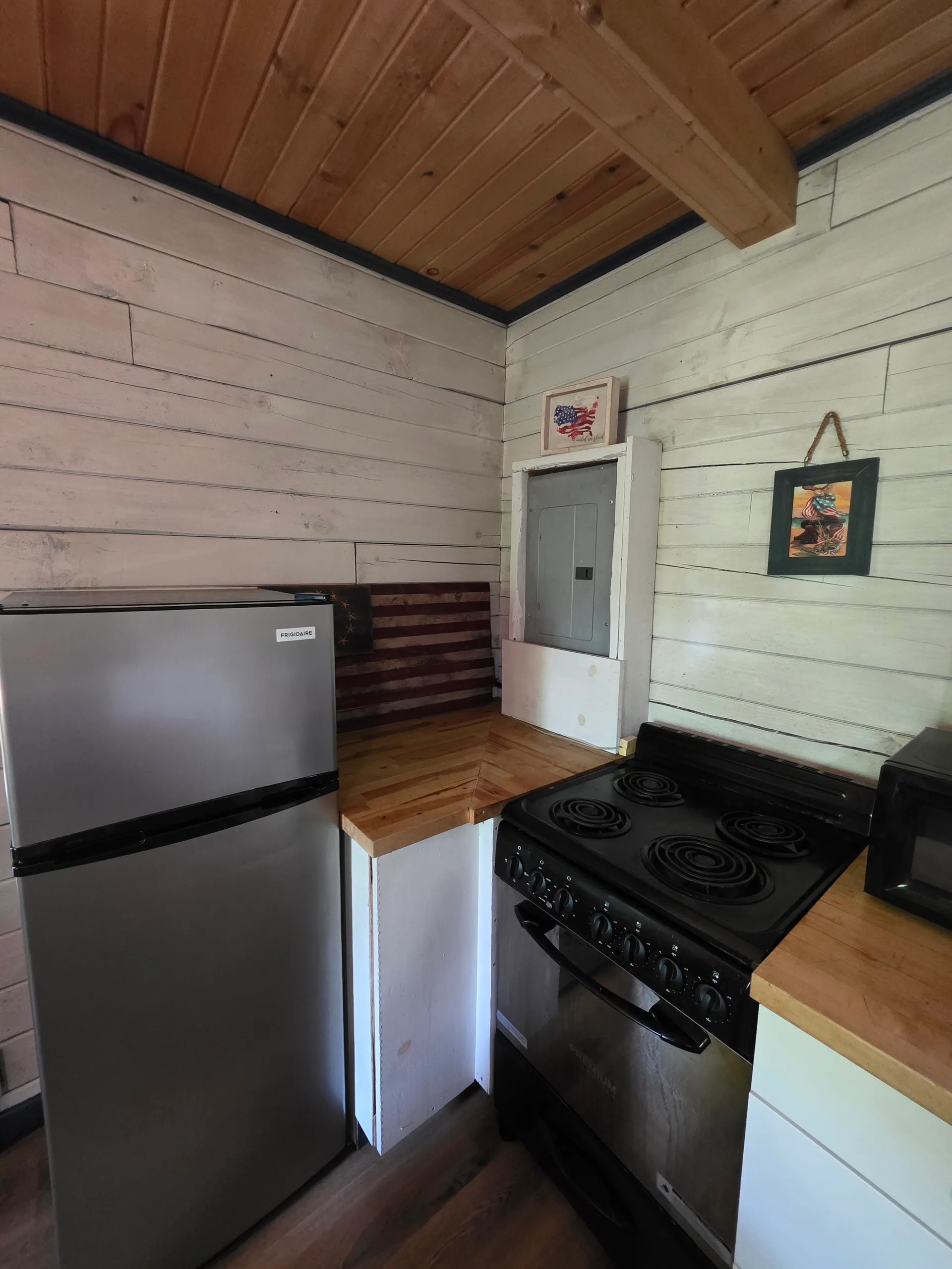 Eagles Nest cabin full kitchen with refrigerator, electric stove, and microwave