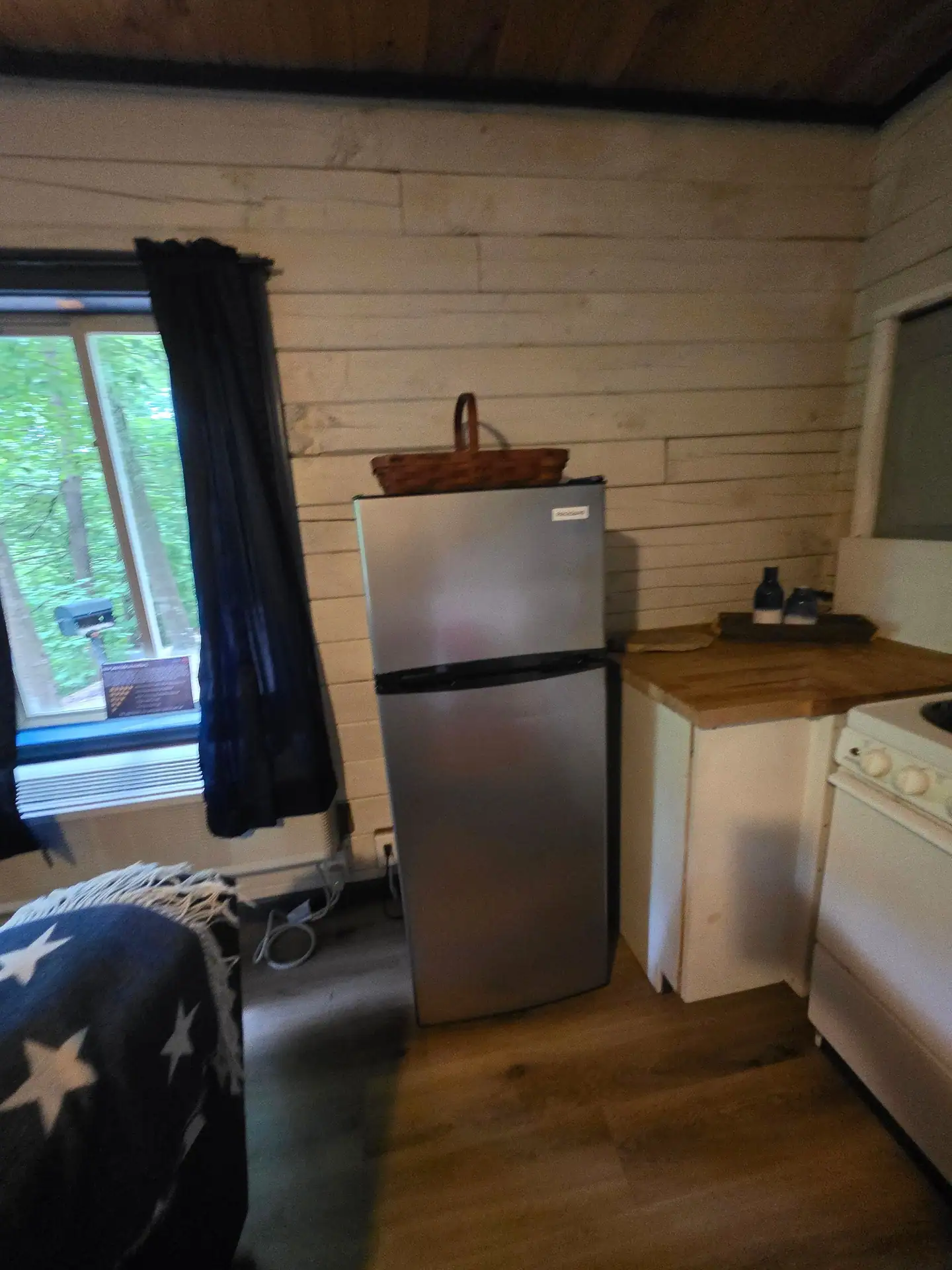 Stainless steel refrigerator next to the kitchen counter in Eagles Nest cabin