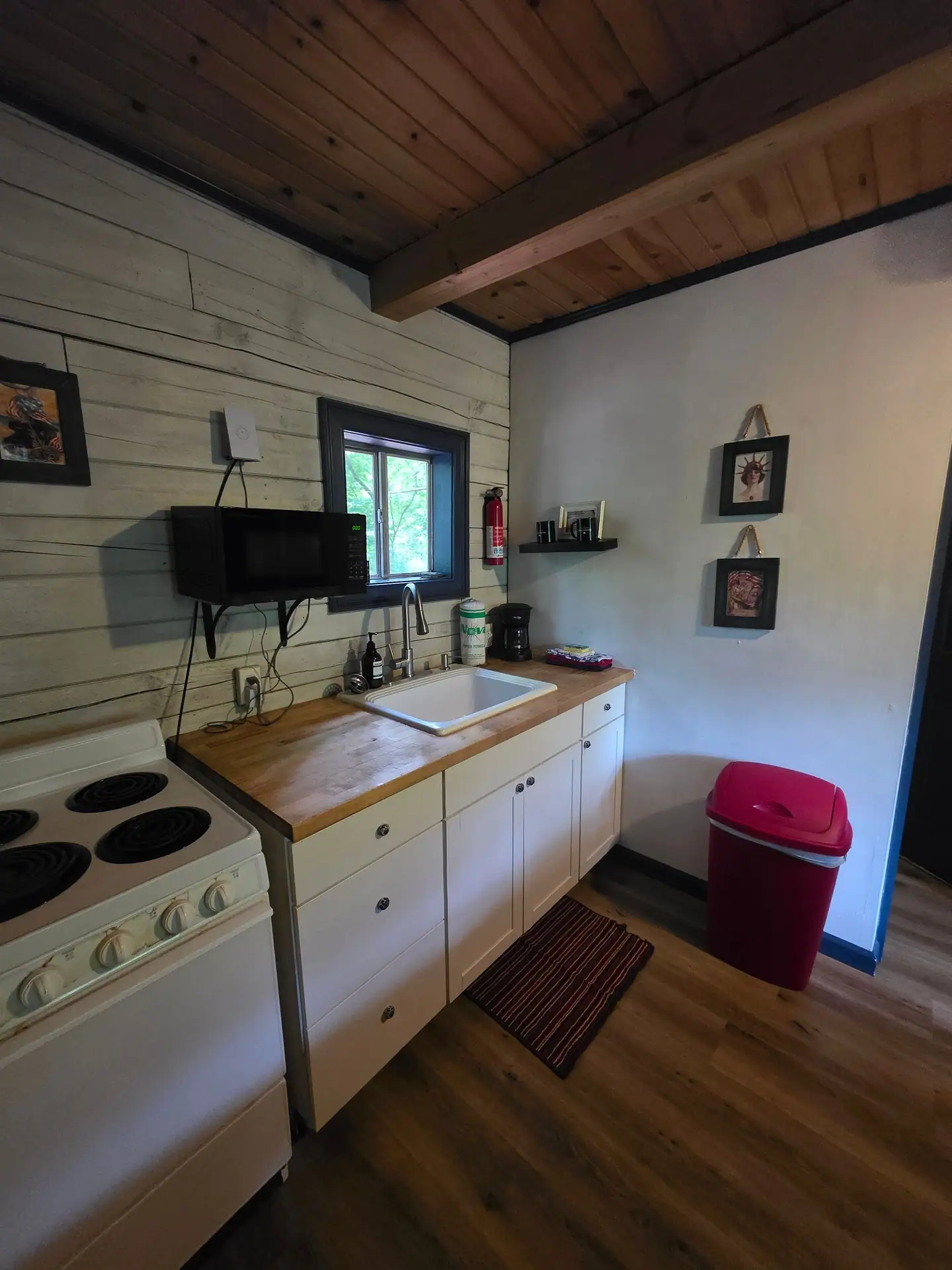 Eagles Nest cabin kitchen with white cabinets, sink and butcher block countertop