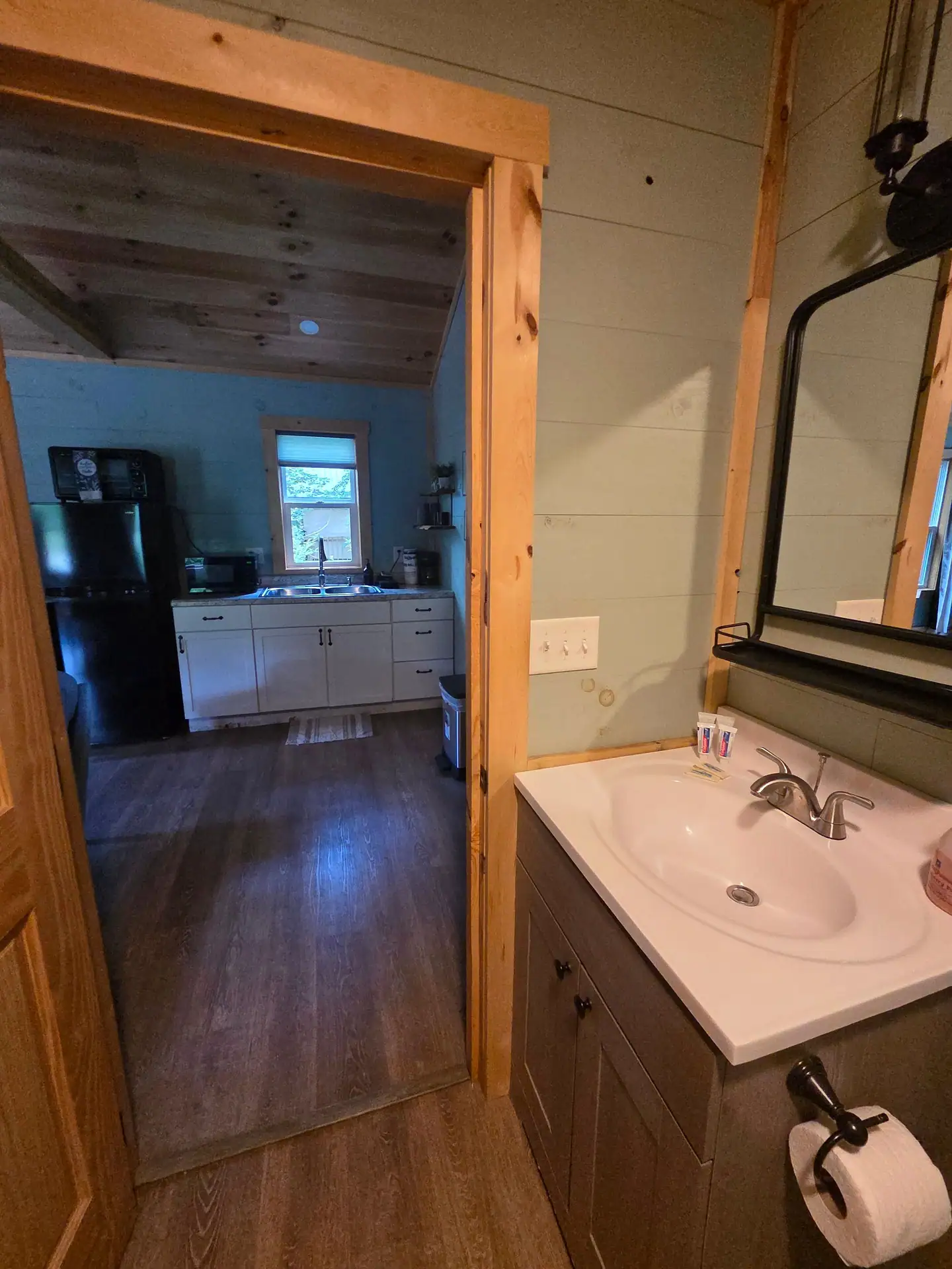View from the bathroom vanity through the door to the kitchenette at Firefly's Landing