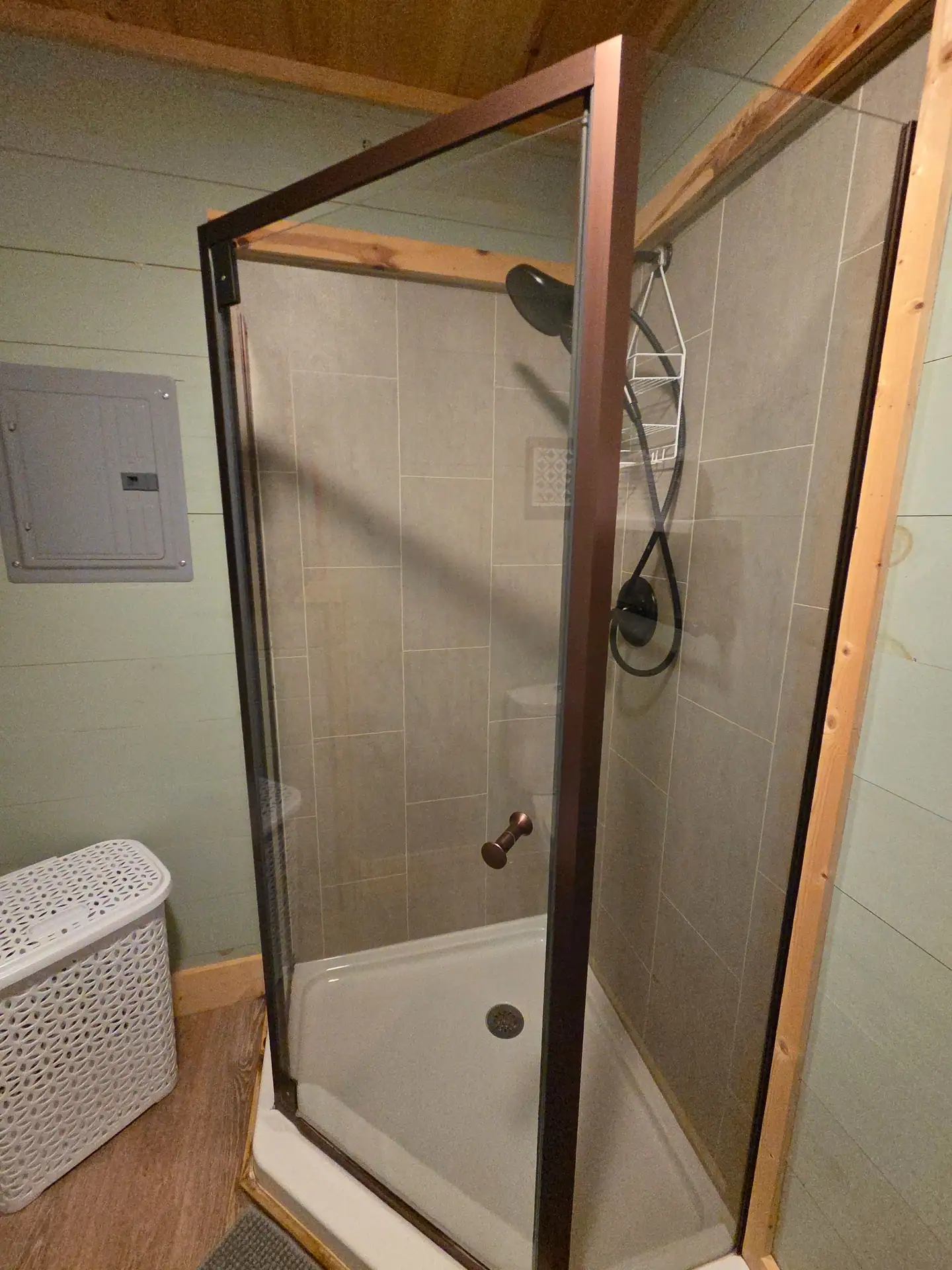 Glass-enclosed walk-in shower with gray tile at Firefly's Landing
