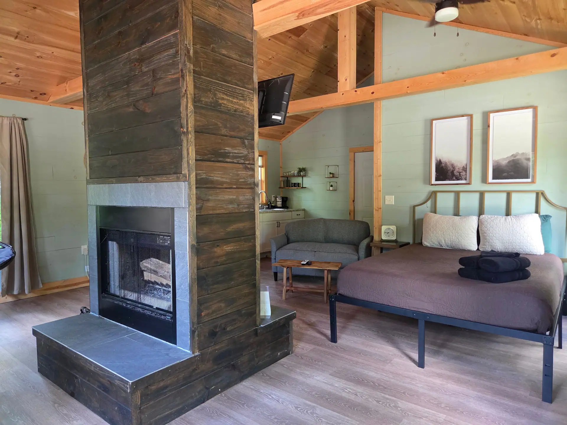 Queen bed facing the double-sided fireplace at Firefly's Landing