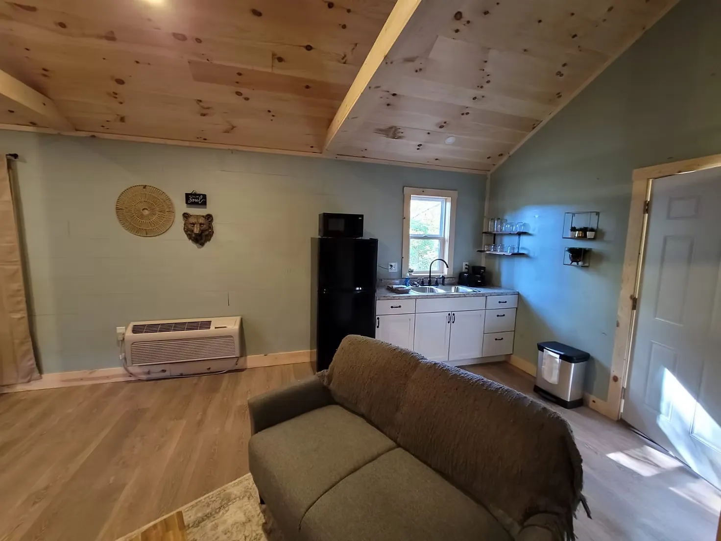 Cozy bedroom with queen bed and double-sided fireplace at Firefly cabin