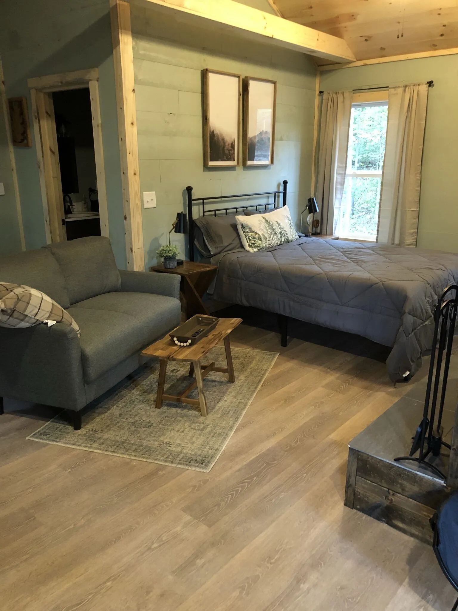 Fire pit area with bench seating surrounded by forest at Firefly cabin