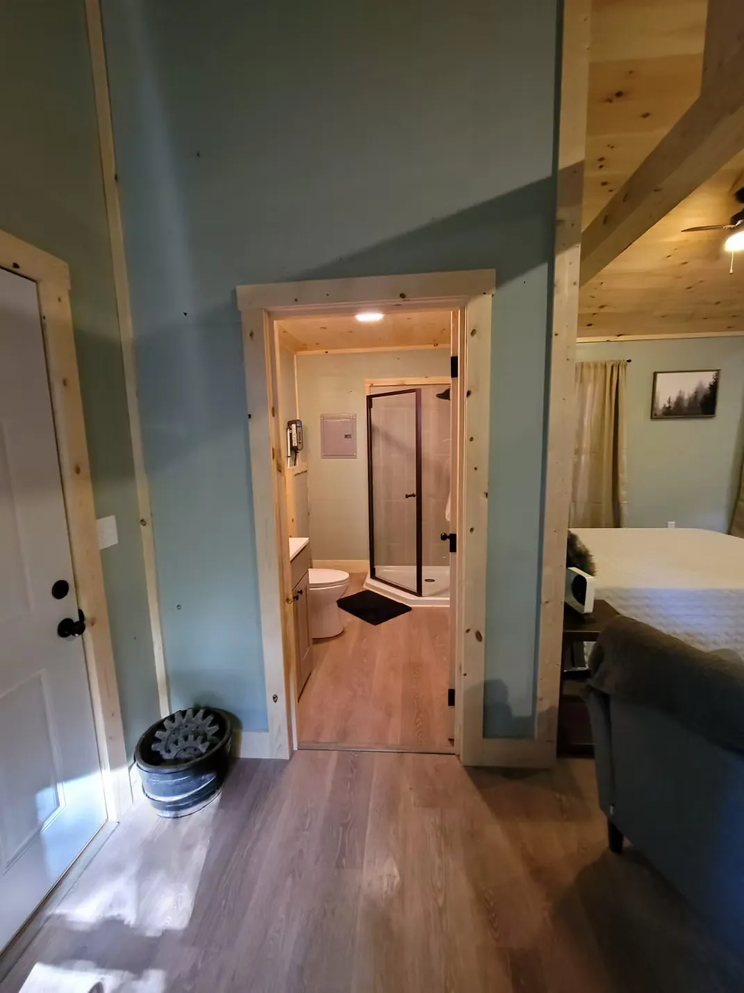Private hot tub on covered deck overlooking the forest at Firefly cabin