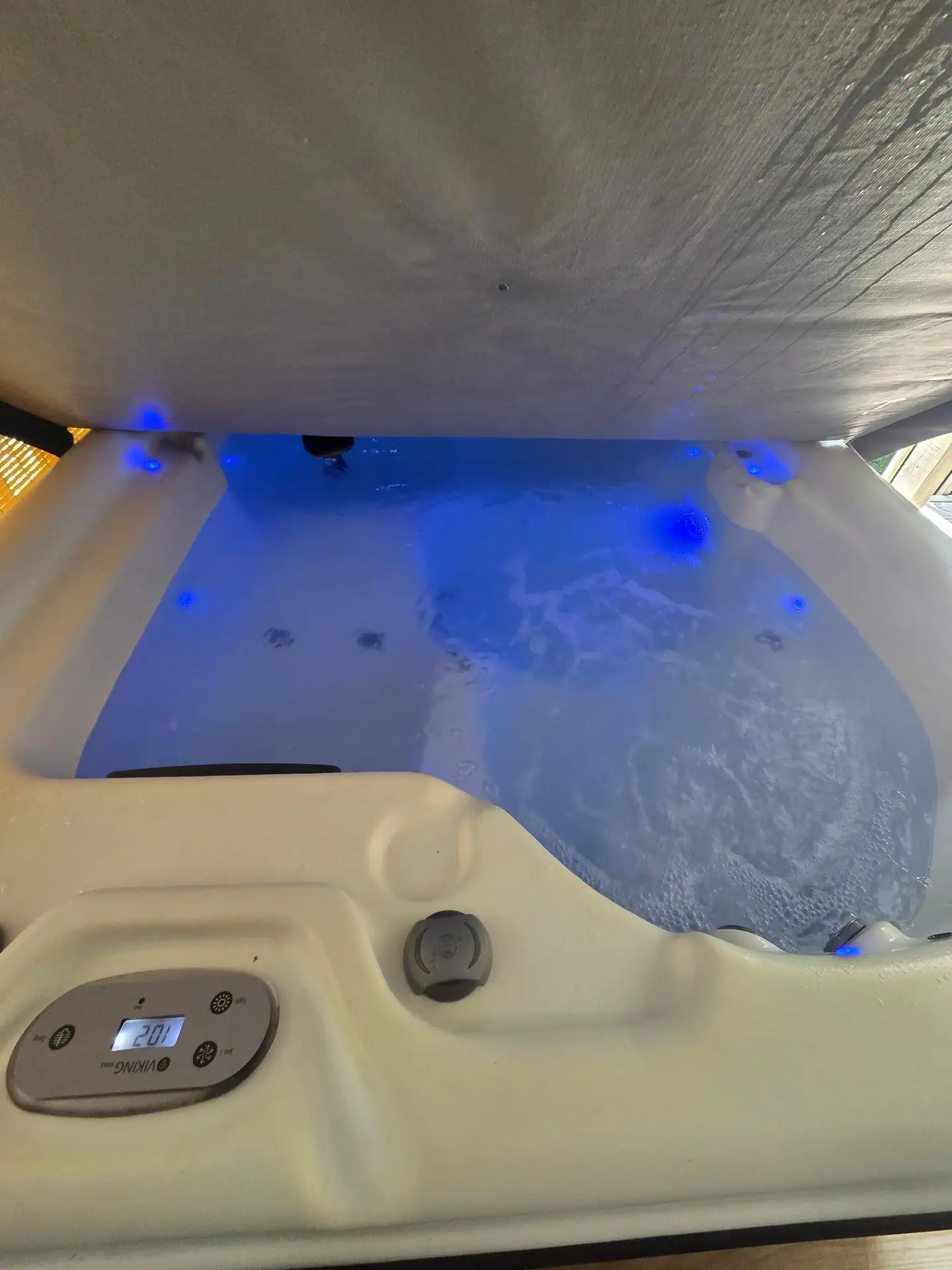 Open hot tub with blue lights and bubbling water at Firefly's Landing