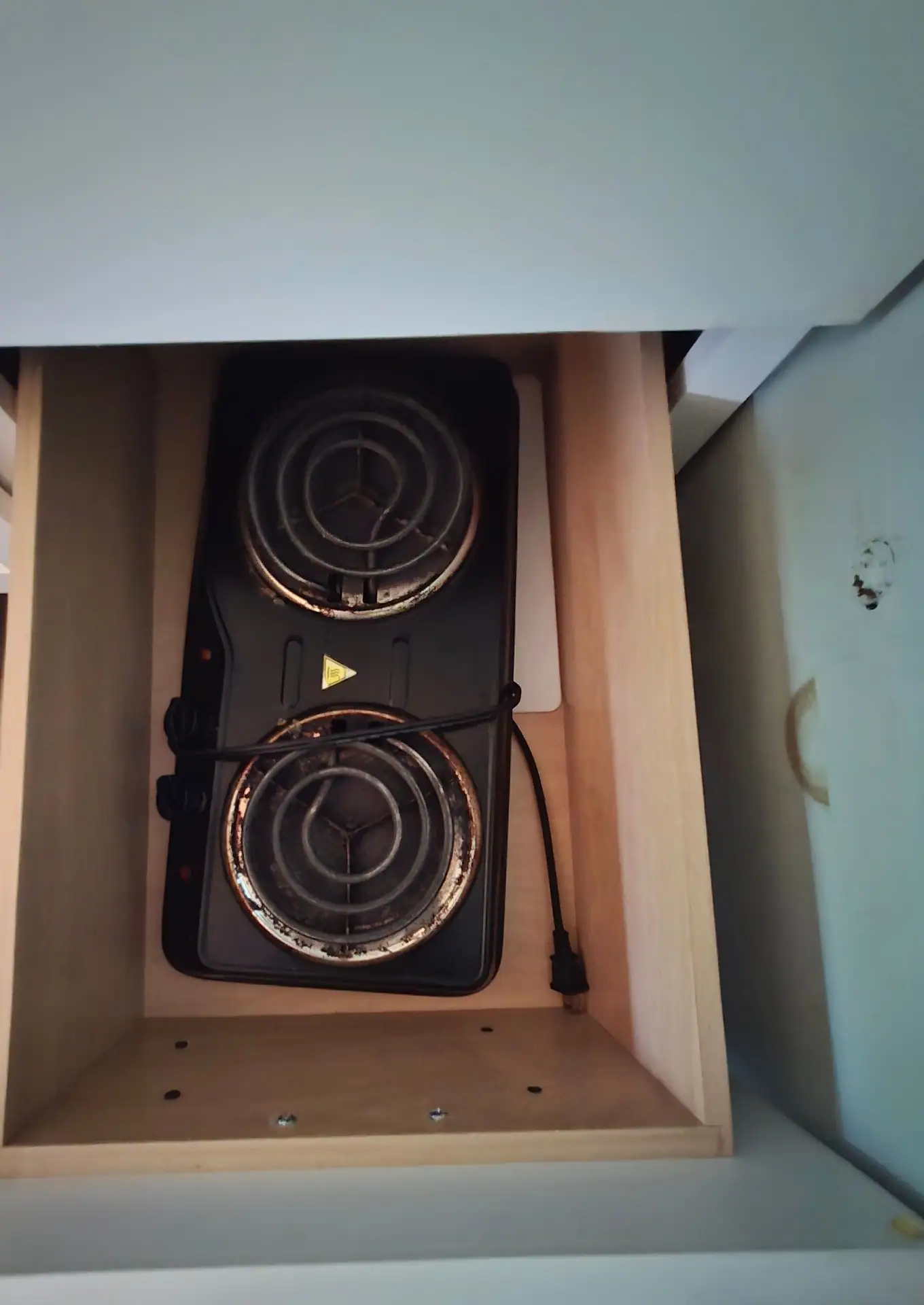 Two-burner electric hot plate stored in a kitchenette drawer at Firefly's Landing