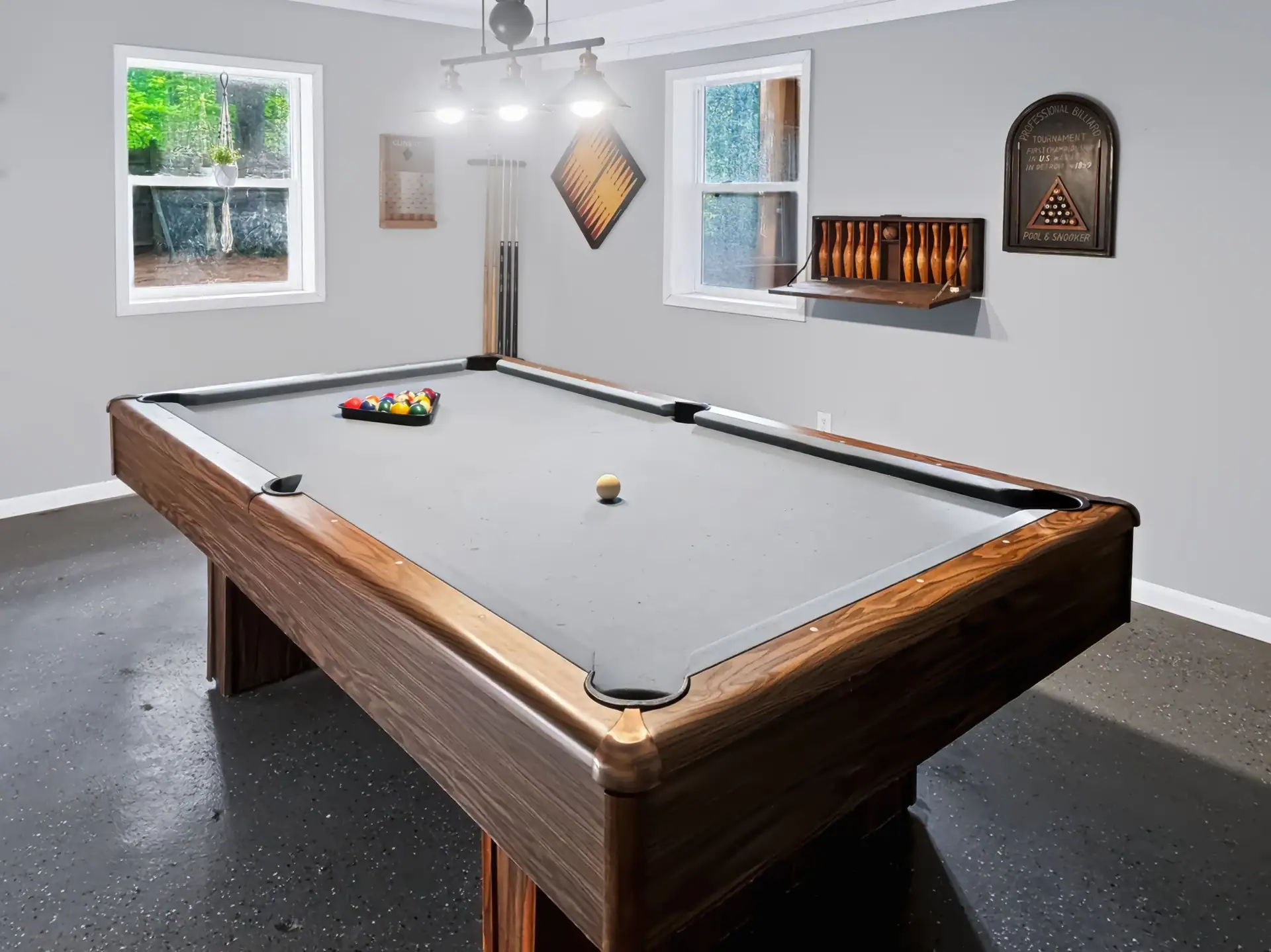 Game room at The Getaway House with a full pool table under a three-light fixture.