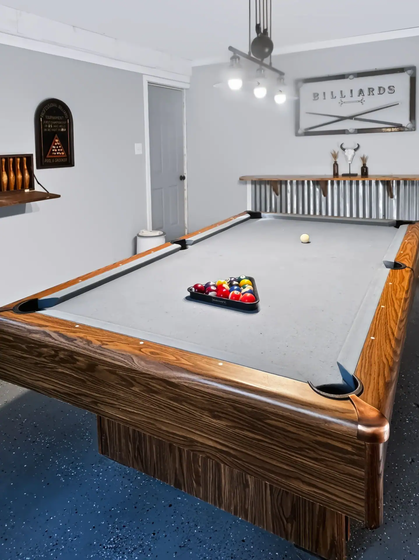 Racked pool table and billiards sign in the game room of The Getaway House.
