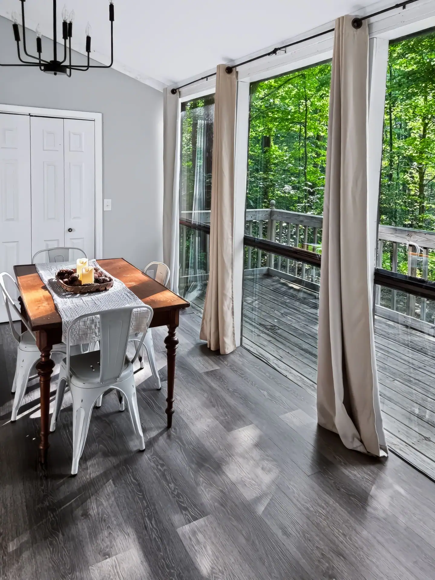 Dining table beside tall windows that open onto the deck at The Getaway House.