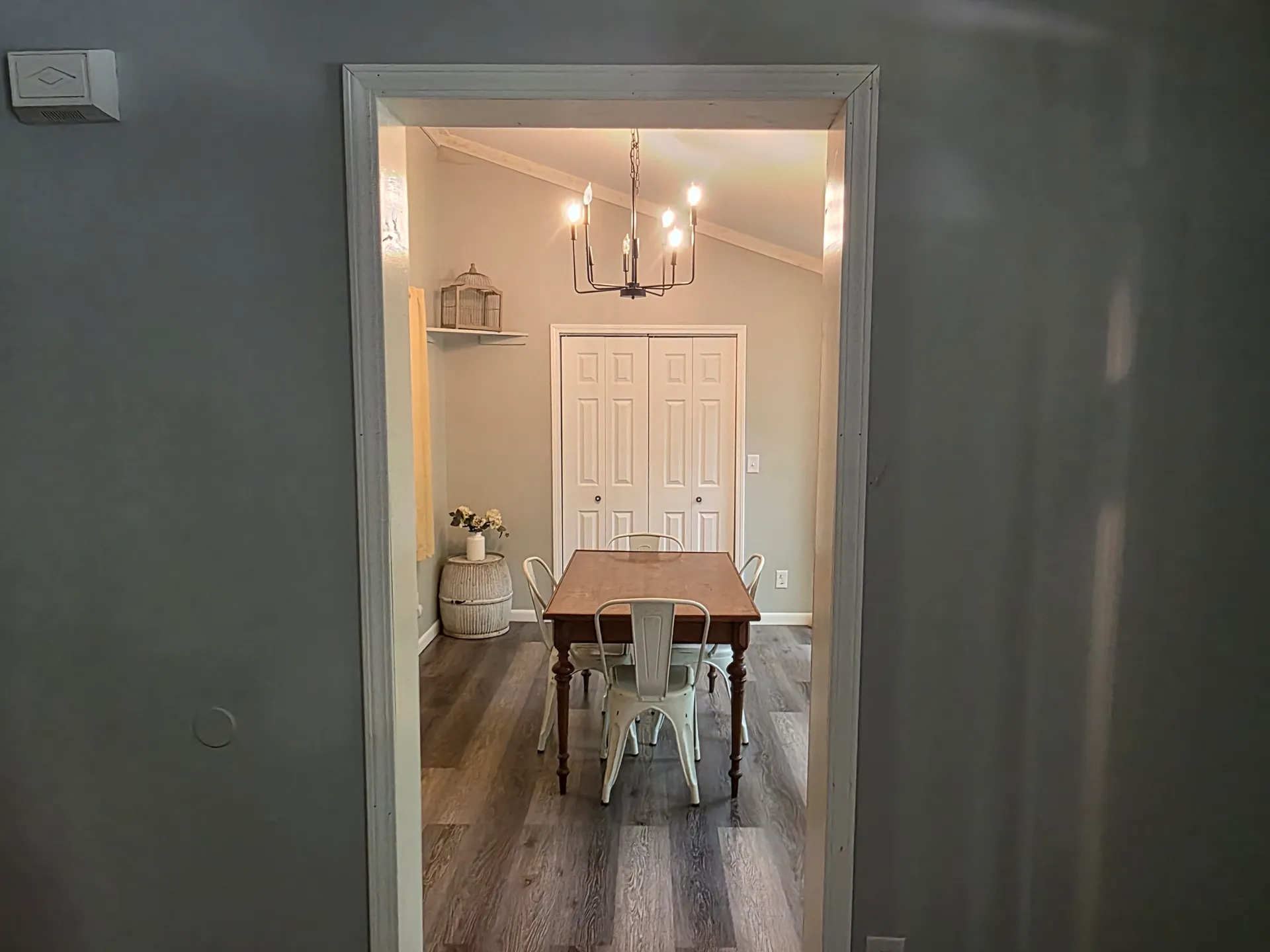 Farmhouse dining table with metal chairs and chandelier at Getaway House cabin