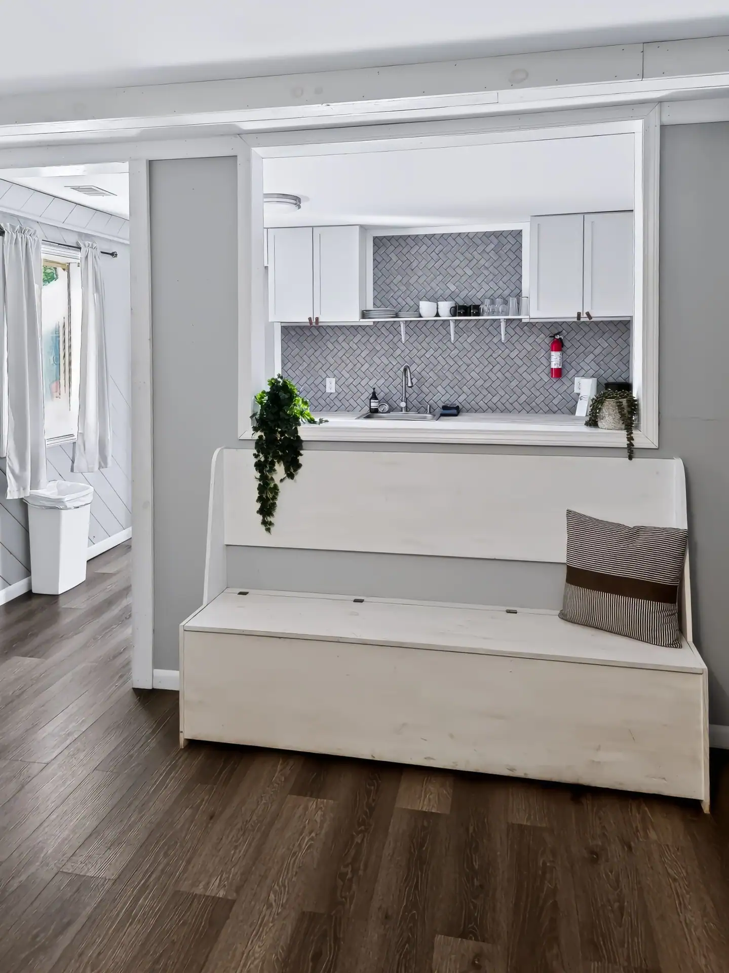 White storage bench below the kitchen pass-through at The Getaway House.