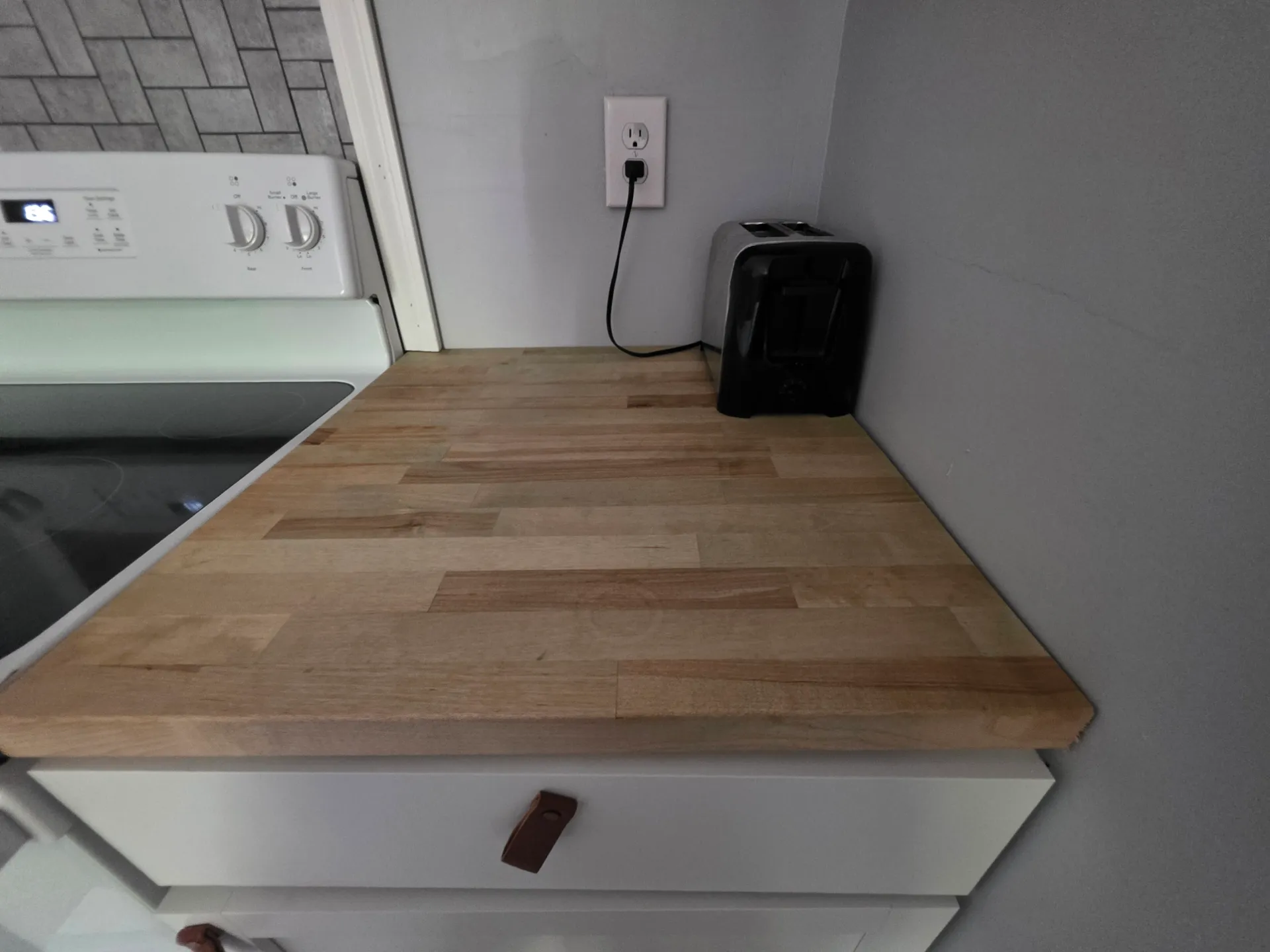 Butcher block countertop with air fryer in the kitchen at Getaway House cabin