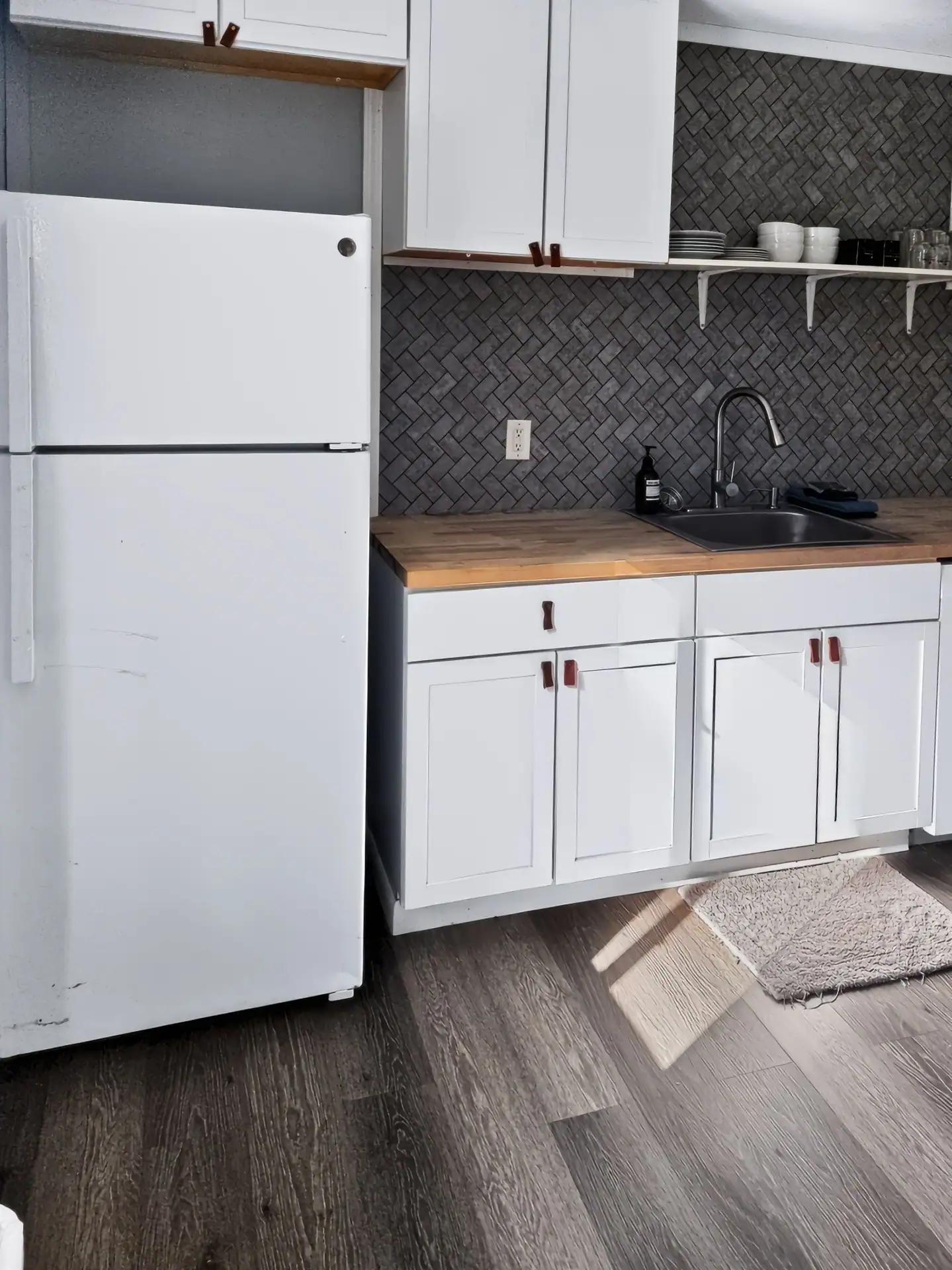 Full-size refrigerator next to the sink in the kitchen of The Getaway House.