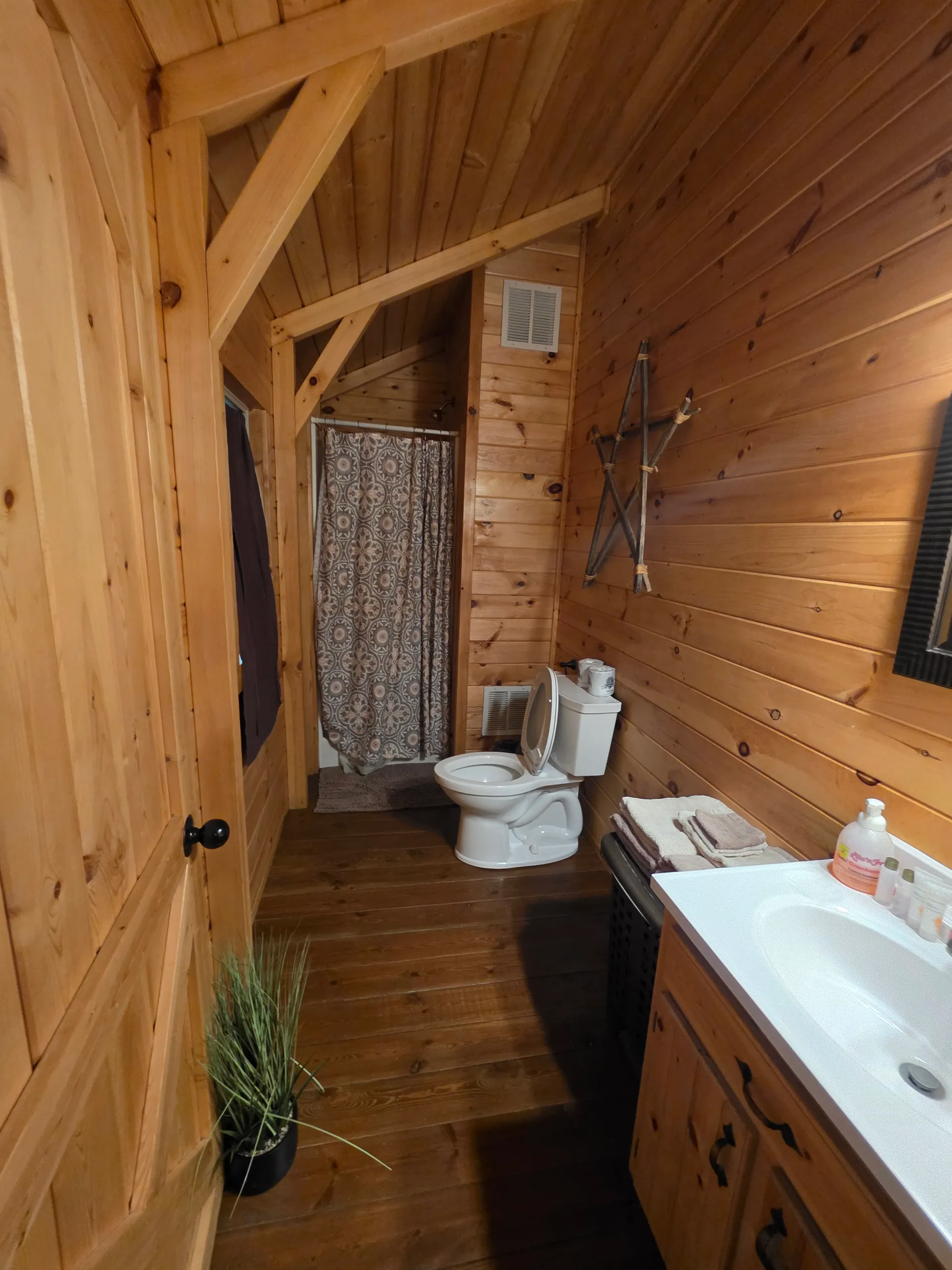 Bathroom with jetted soaking tub and pine-paneled walls at Millers Den cabin