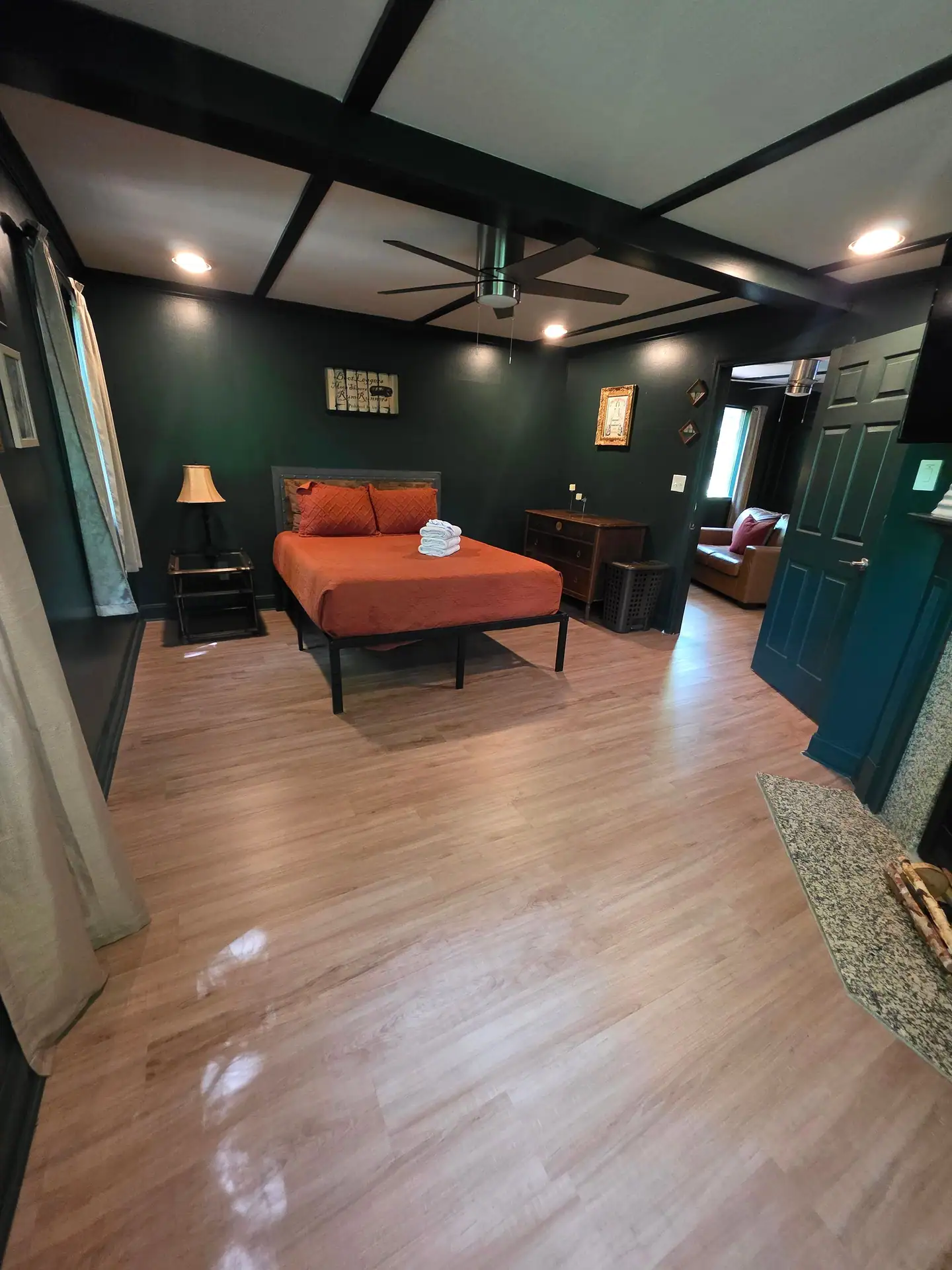 Bedroom seen from the doorway with queen bed and beamed ceiling at The Old Moonshiner cabin