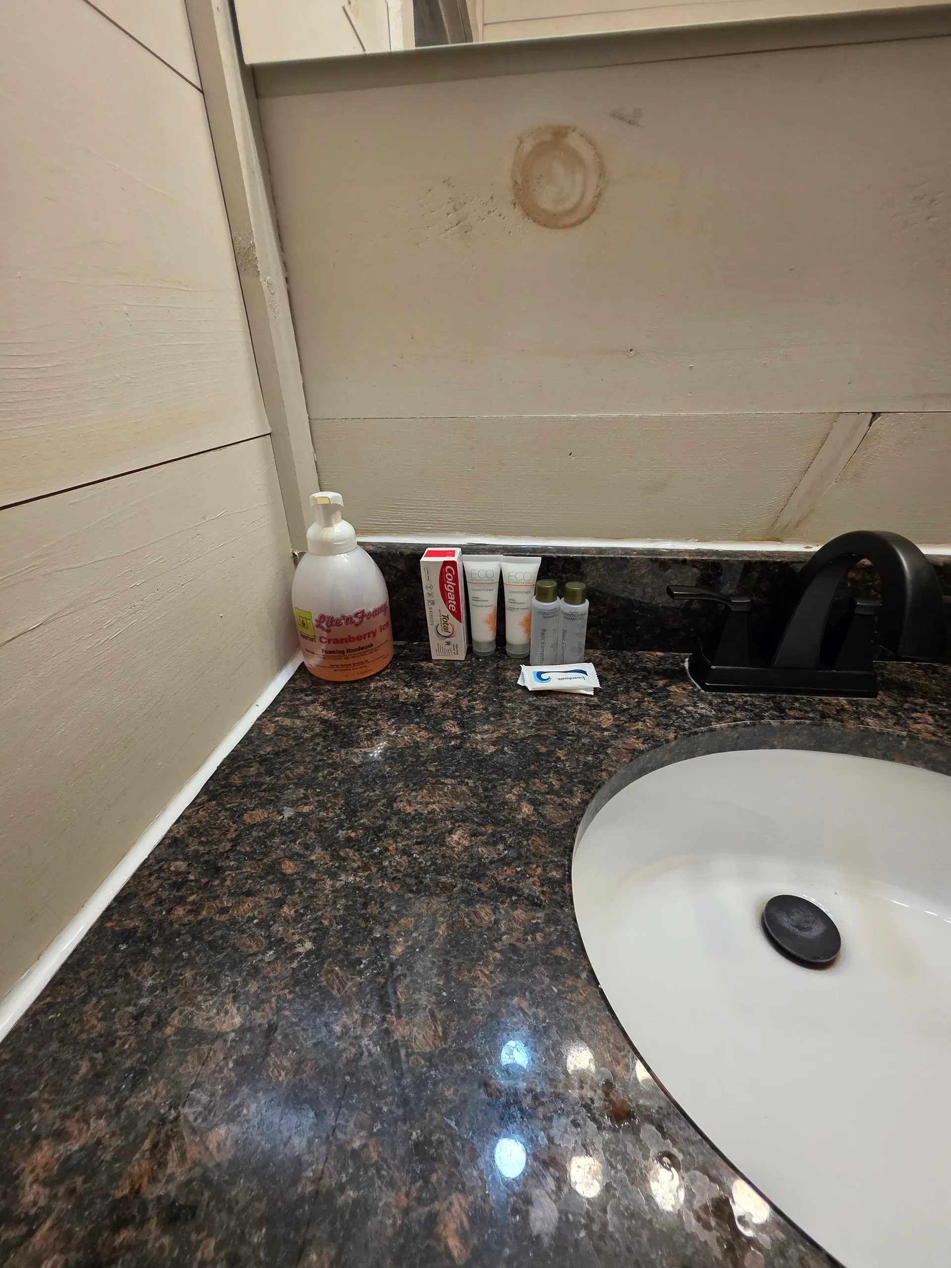 Bathroom vanity with granite countertop and oil-rubbed bronze faucet at Owl's Tale cabin