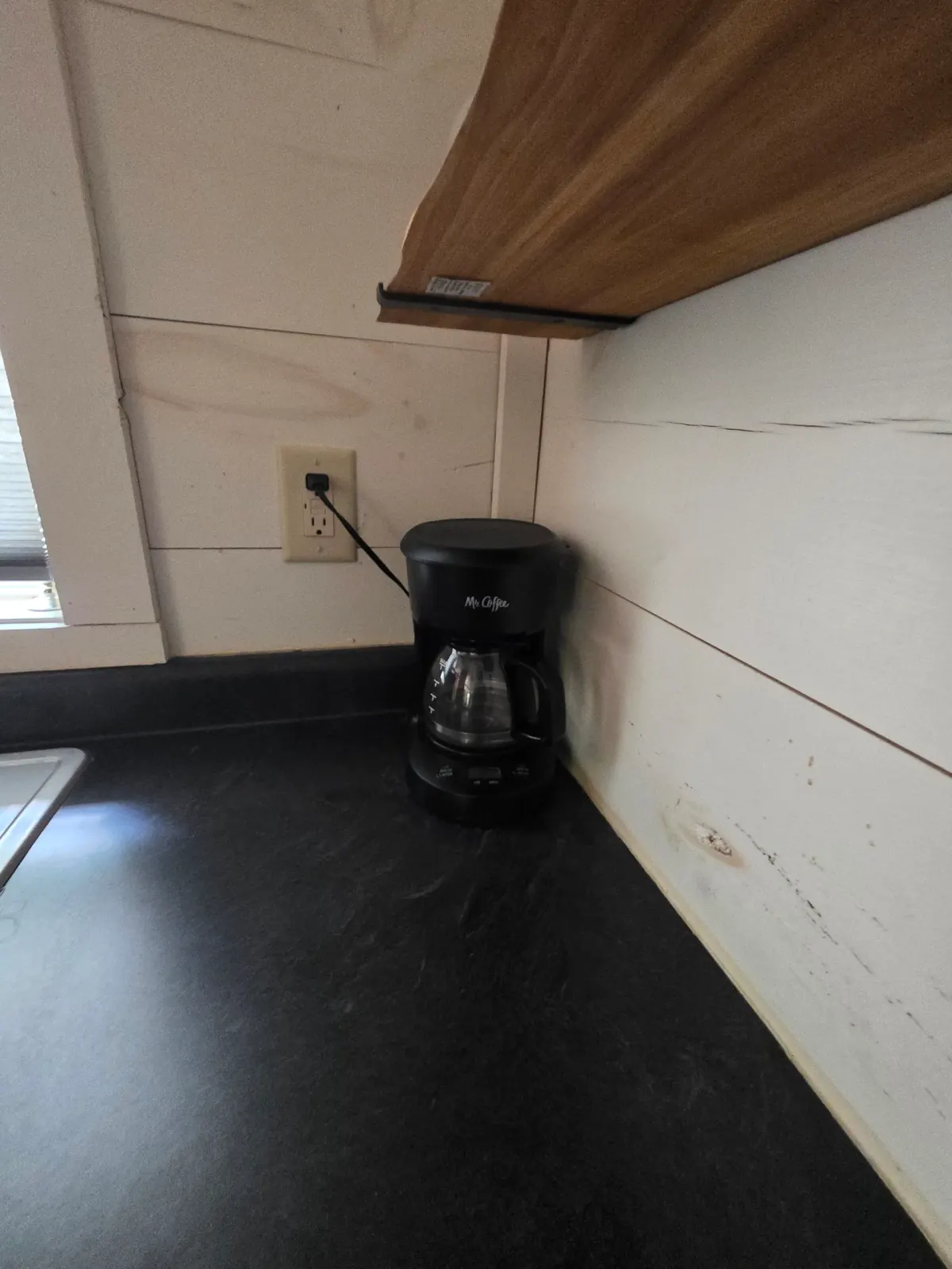 Coffee maker on the dark countertop at Owl's Tale cabin kitchenette