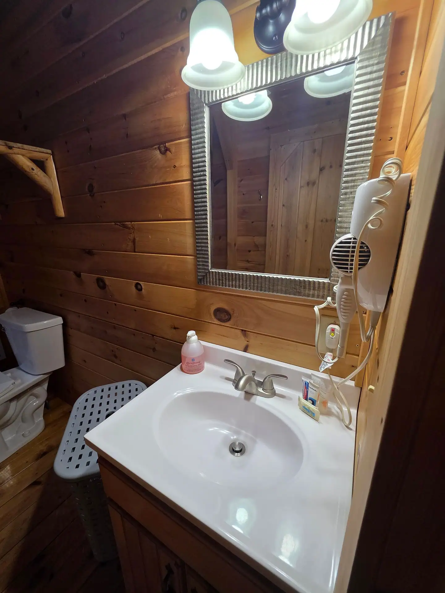 Bathroom vanity with mirror and hair dryer at Whippoorwill
