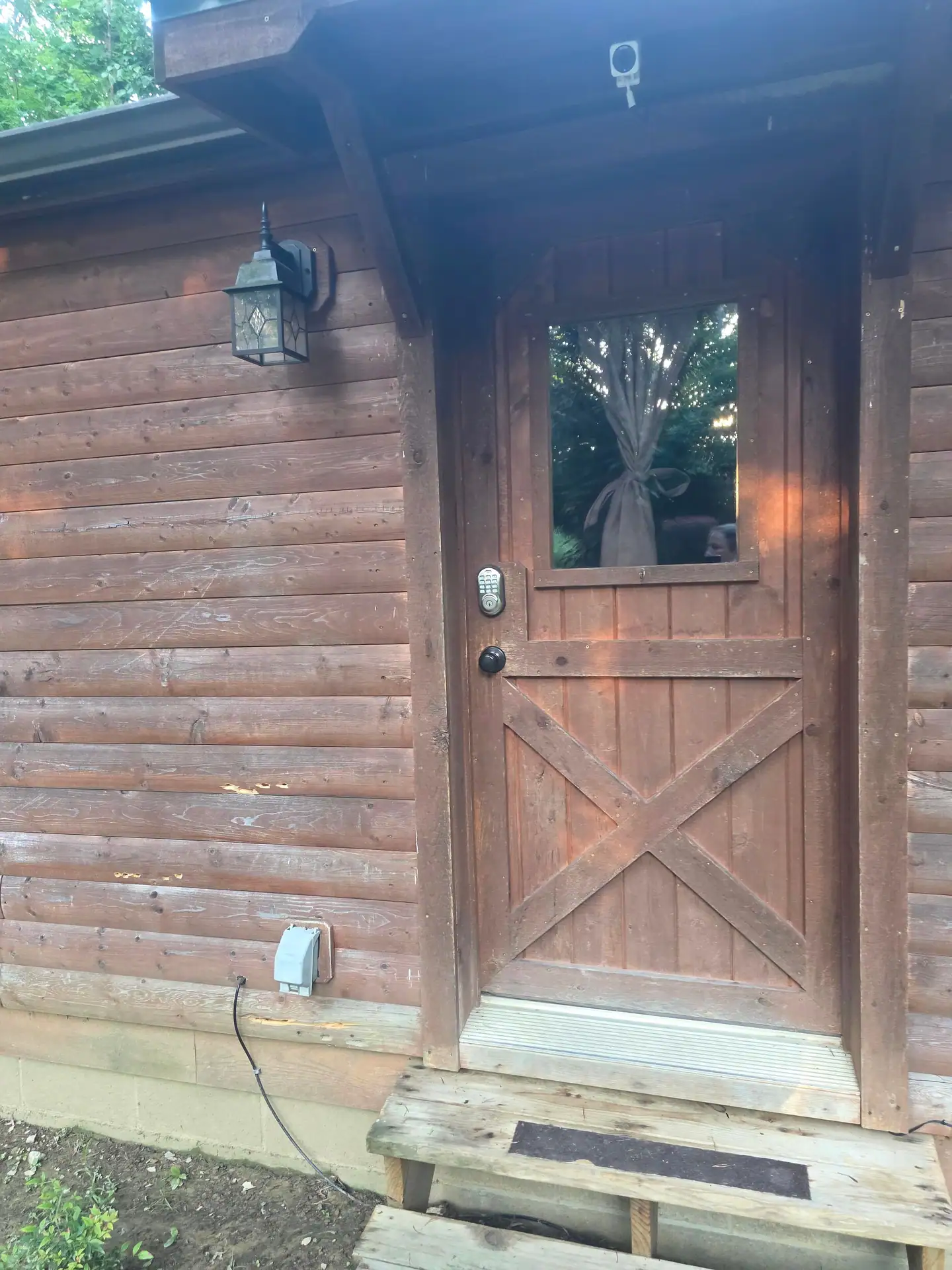 Wooden front door and entry steps of Whippoorwill cabin