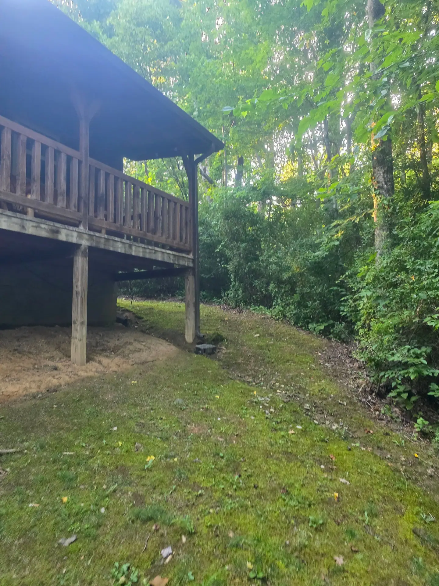 Back of Whippoorwill cabin with the raised covered deck facing the woods