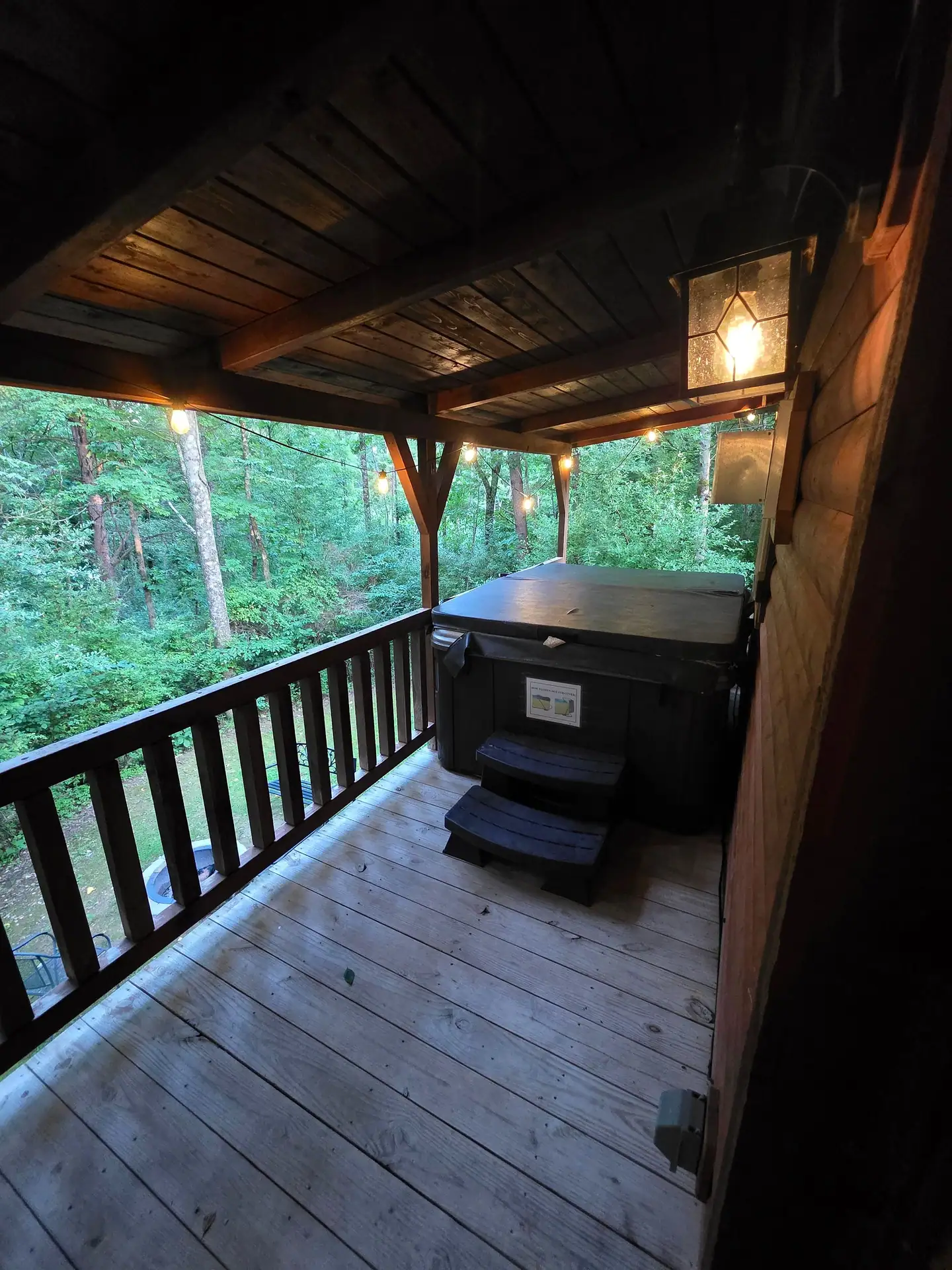Private hot tub on the covered deck at Whippoorwill facing the woods