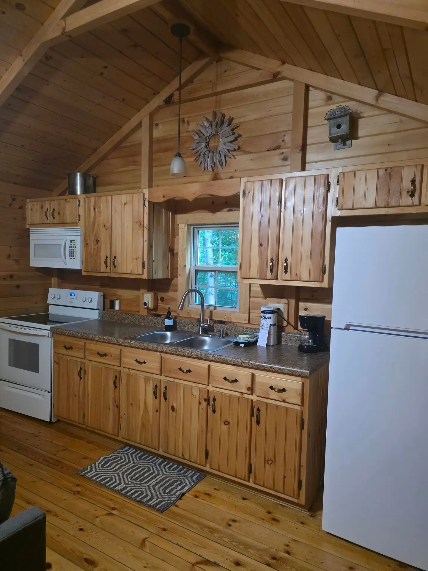 Full kitchen at Whippoorwill with stove, microwave, sink and full-size fridge