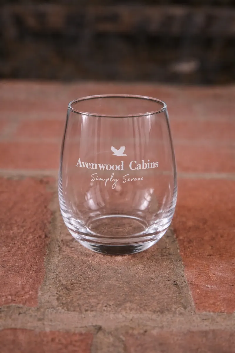 An etched Avenwood Cabins wine glass